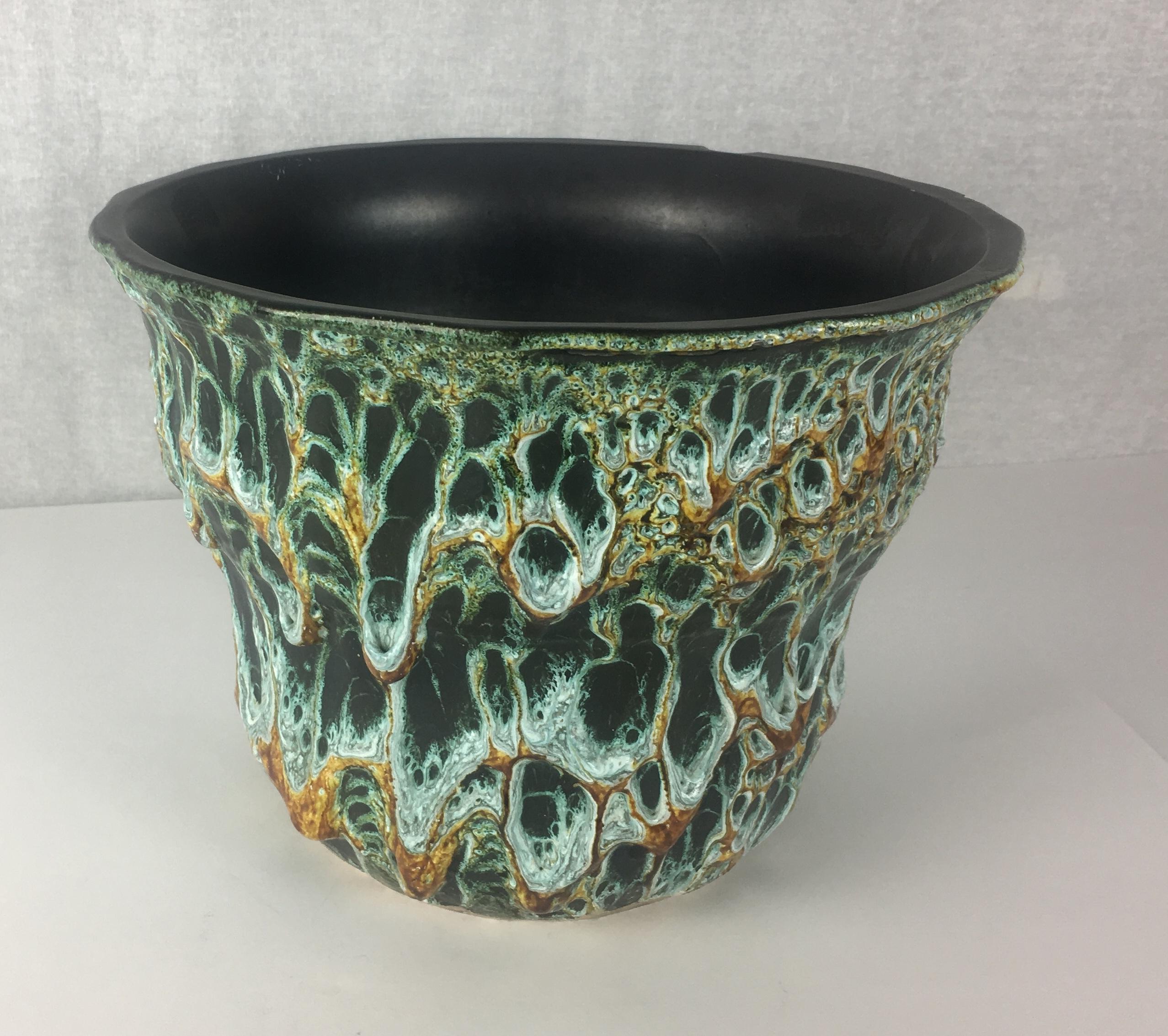 A stunning Fat Lava Studio planter by Charles Cart, circa 1960. 
The distinctive glaze on this planter that was developed by Charles Cart the founder of the Le Cyclope Pottery brand in Annecy-le-Vieux in the Haute Savoie area of France. The firing