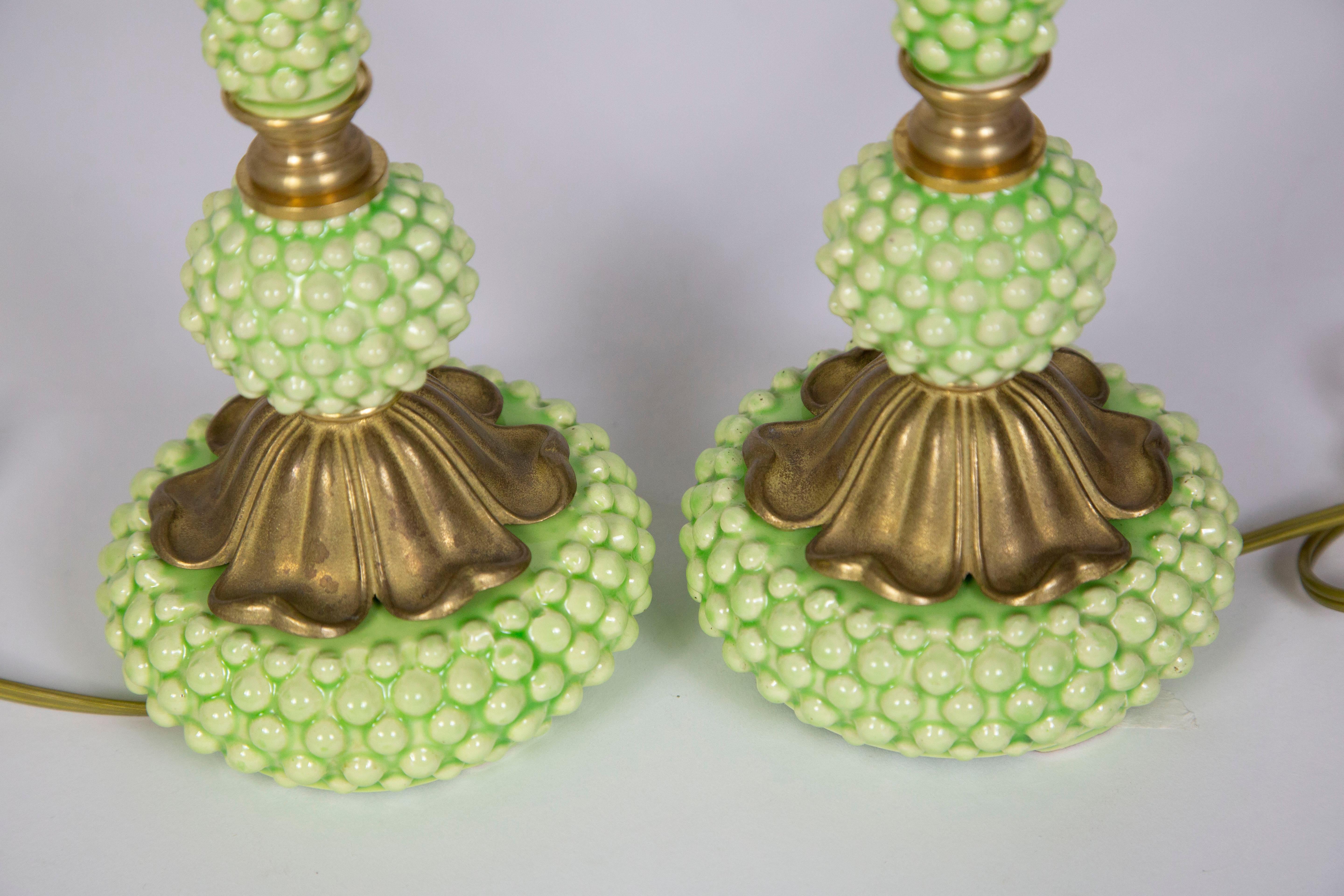 Midcentury, hobnail ceramic lamps in a mod mint - chartreuse green. We rewired them to include pull chain sockets and updated brass accents. They are perfect for side tables and nightstands; petite in size. Matching brass color, plastic cord. Use a