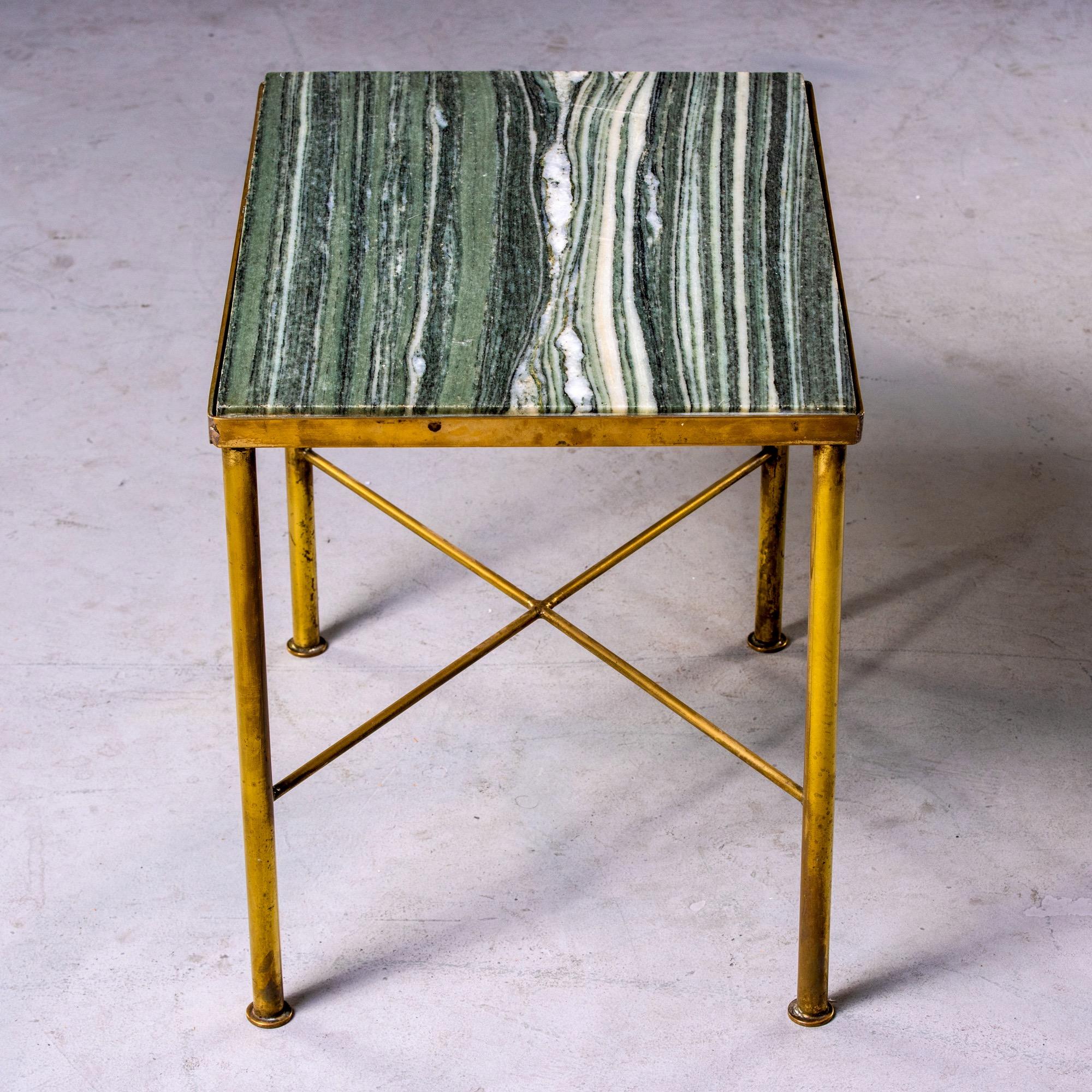 Found in England, this circa 1960s side table has a slender brass frame with X-form stretcher and green marble table top. Unknown maker.

 