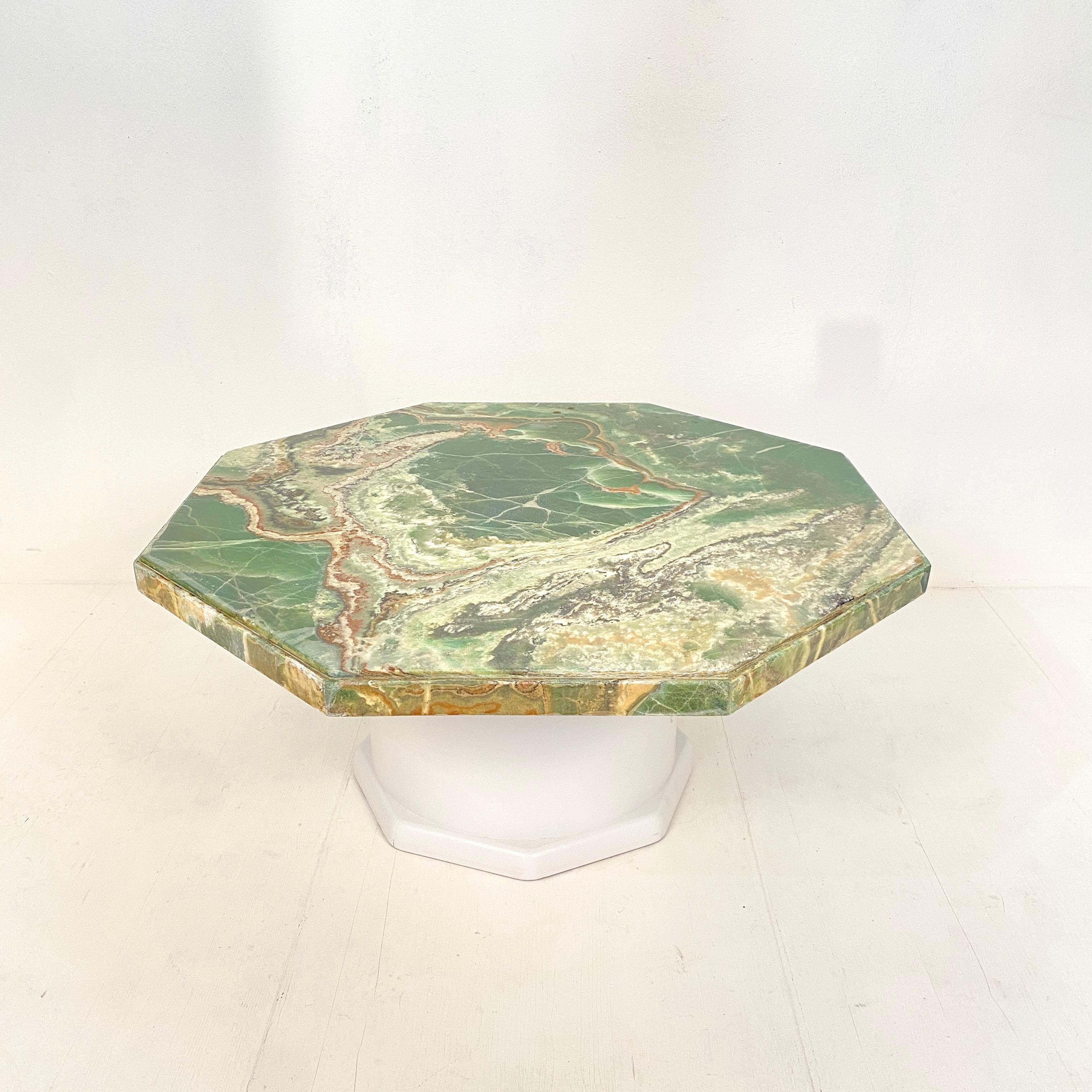 This beautiful midcentury coffee table was made in the 1970s in Germany.
The top has an octagon shape and is made out of green onyx. The round wood base is re-painted in an off white color.
The table is in good vintage condition. The top has be