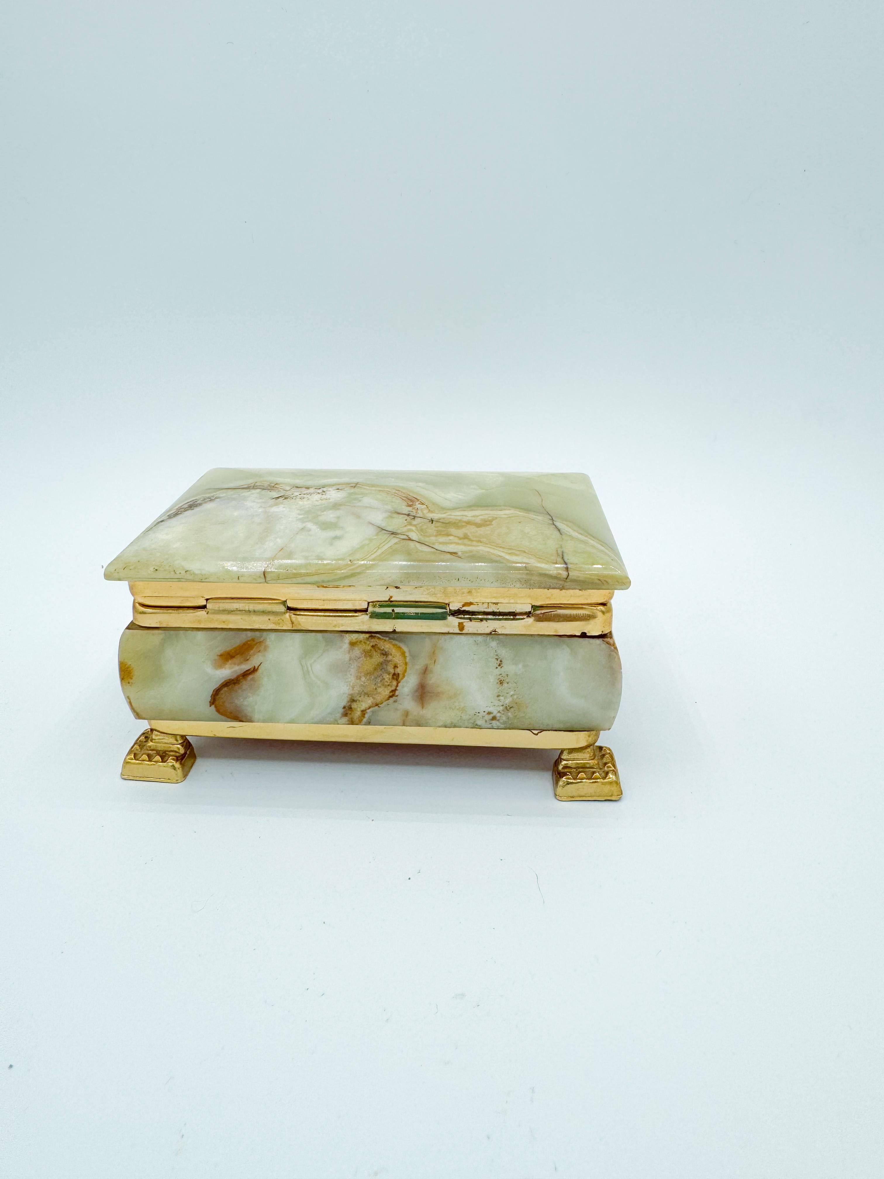 Elevate your cherished belongings with this exquisite vintage green onyx jewelry box. Crafted with meticulous attention to detail, this stunning piece features a smooth, polished green onyx exterior with natural veining, ensuring each box is