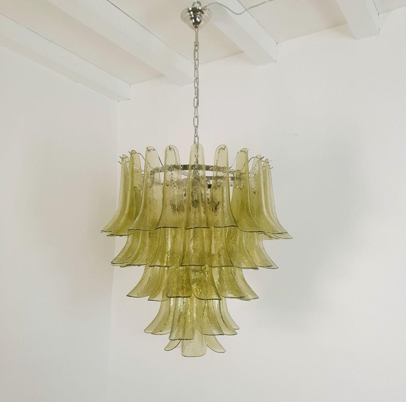 Mid century modern five-tier Green Murano glass chandelier, by Mazzega Italy 1970s.
Two chandeliers - a pair available.
Priced and sold individually.
The Vintage Murano chandelier is made of delicate handmade olive green glass, and a chrome