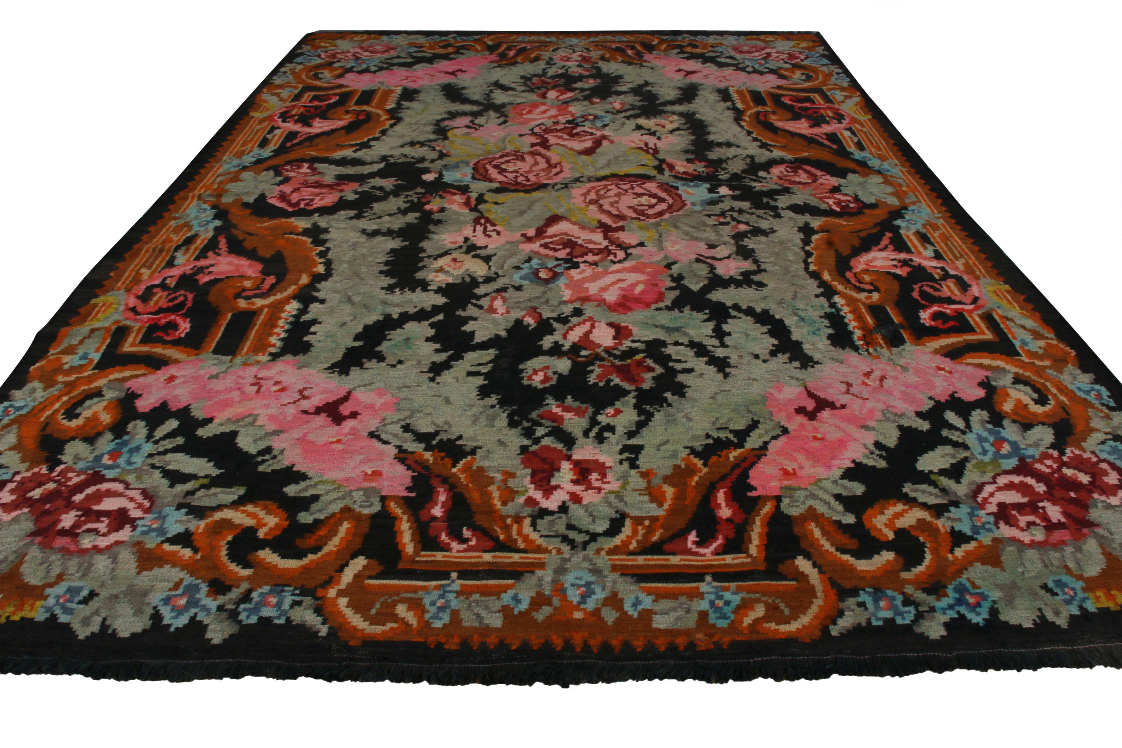 A Turkish approach to a style that originated in Romania, this vintage Bessarabian Kilim rug was handmade in Turkey with a wool flat-weave circa 1950-1960. Set against a picturesque black background complementing the green leaves from its flowers,