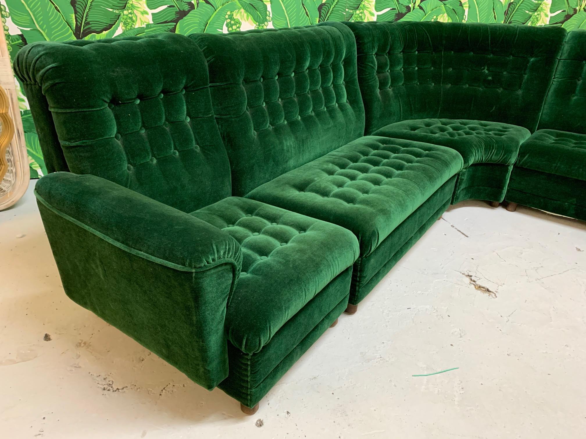 Large midcentury 5-piece sectional sofa features a deep, rich emerald green velvet upholstery and a tufted high back form. Very good condition with only very minor imperfections consistent with age. Total length is 115