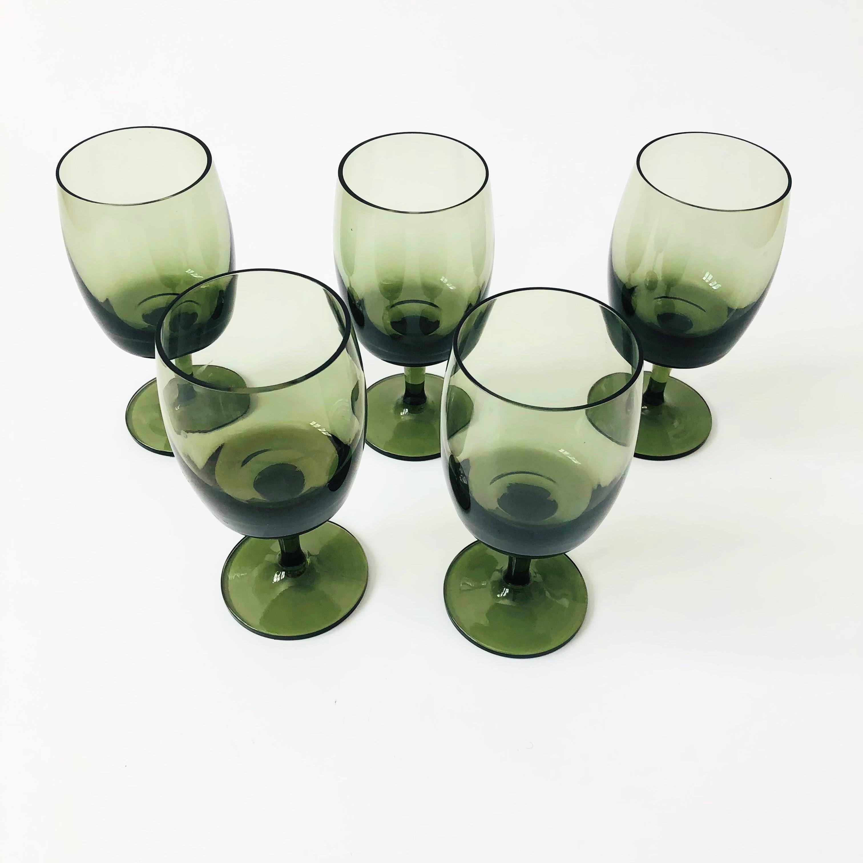 A set of 5 mid century wine goblets. Lovely muted green color to the glass with elegant tapered stems. Made by Gorham Reizart, handblown in Bavaria West Germany.

