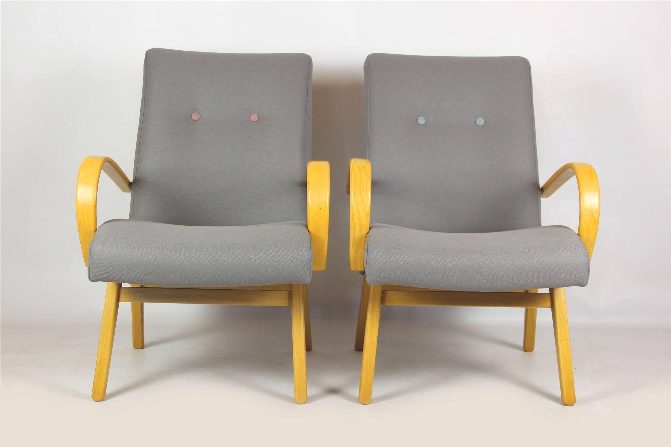 This pair of armchairs are from the mid-1960s and were made in former Czechoslovakia. The armrests are made out of beech bentwood.
Completely restored, satin lacquered woodwork, upholstered in grey and pastels fabric.