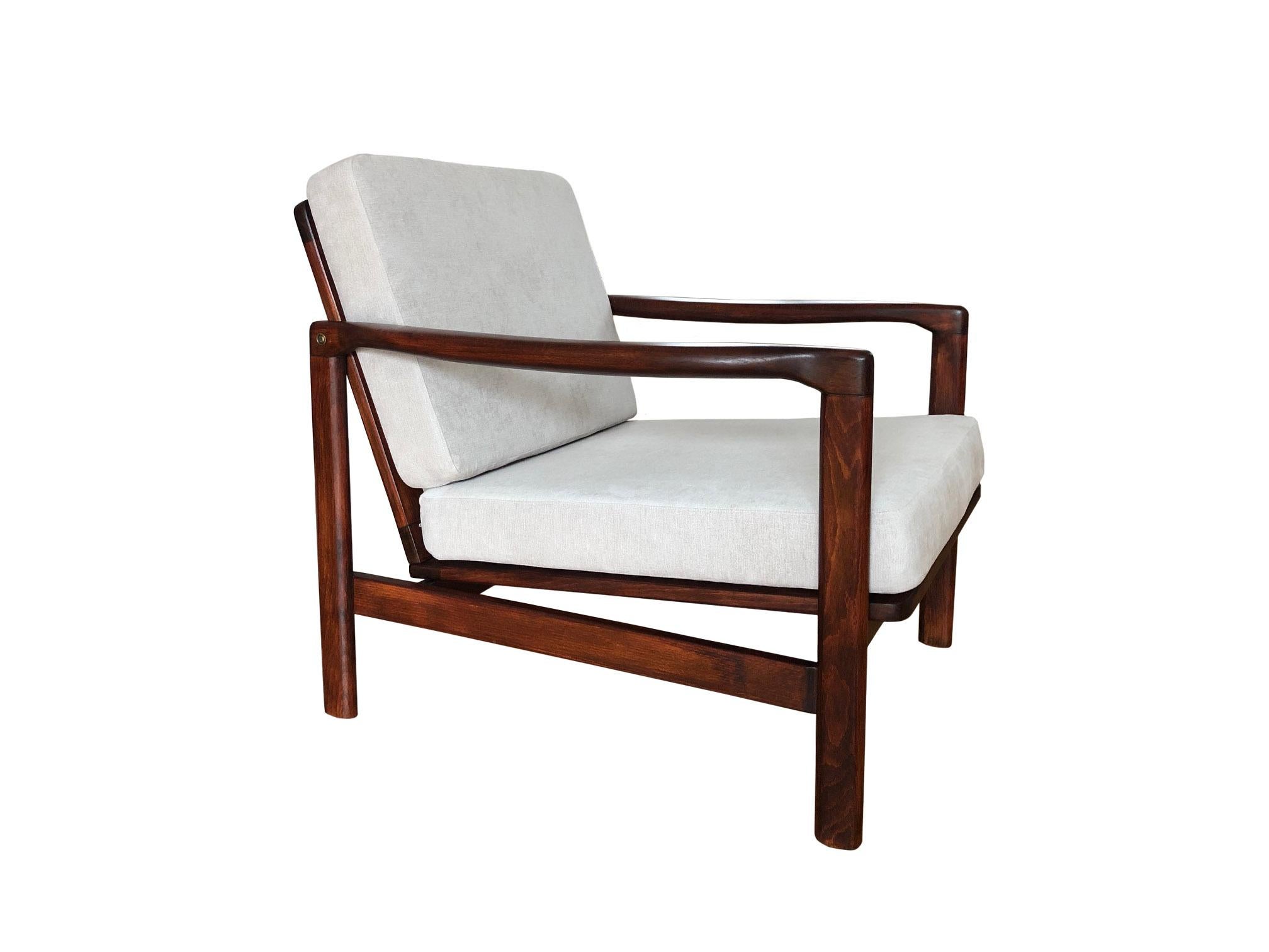 The lounge chair model B-7752, designed by Zenon Baczyk, has been manufactured by Swarzedzkie Fabryki Mebli in Poland in the 1960s. 

The structure is made of beech wood in a warm walnut color, finished with a semi matte varnish. The upholstery is