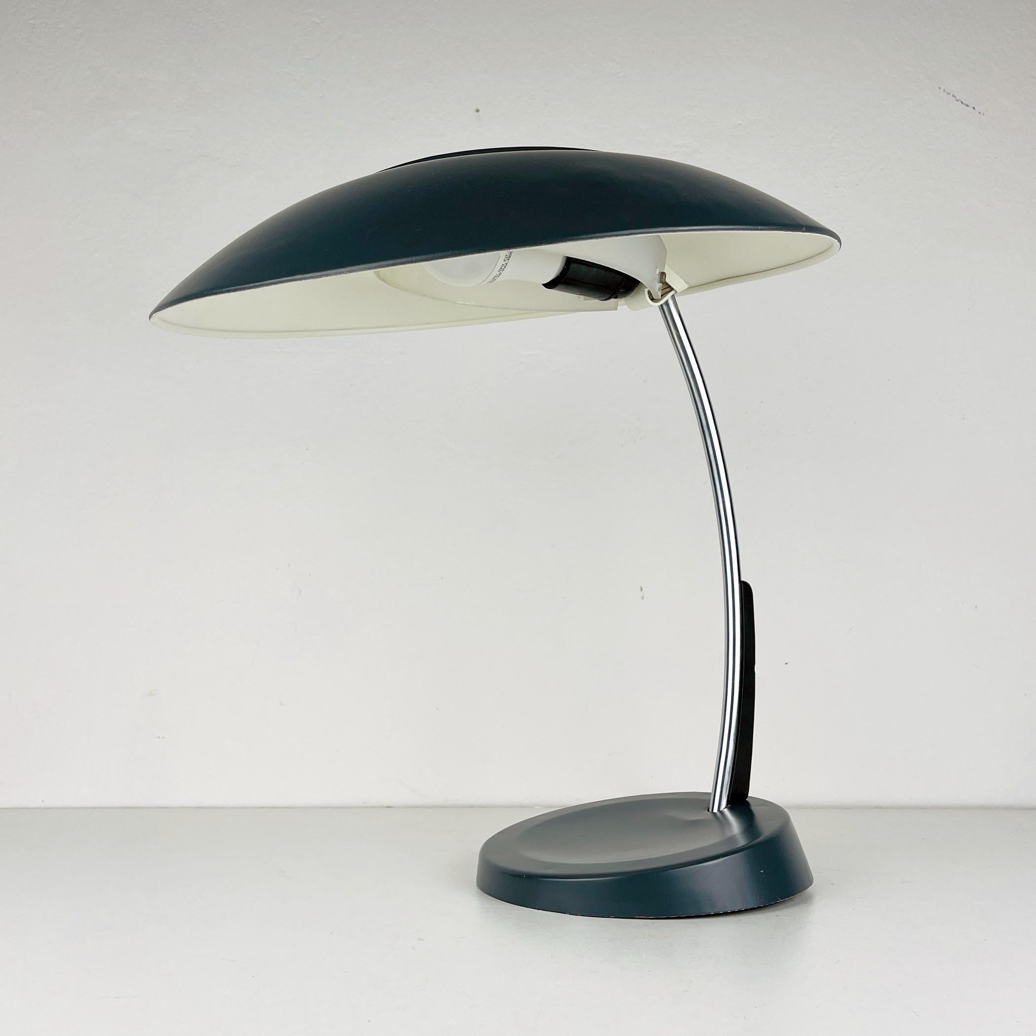 Illuminate your space with this vintage gray desk lamp, a product of the USSR in 1972. Crafted entirely from metal, this lamp boasts a sturdy and stable base, ensuring it stands the test of time. Designed for E27 bulbs with a screw fitting, this