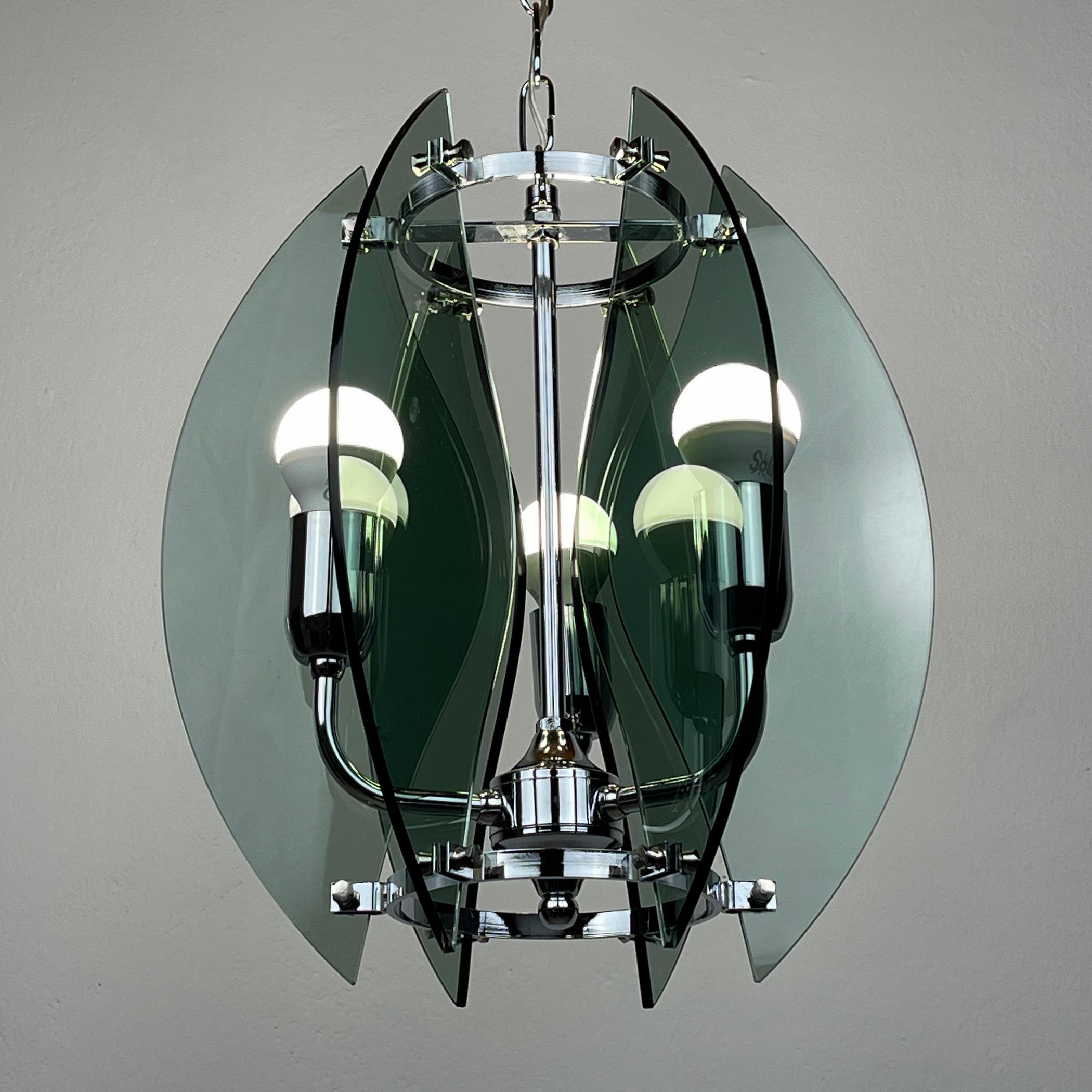 Enhance your space with the timeless charm of this vintage Italian pendant lamp, a true gem from the 1980s. Crafted by Veca, renowned for their exceptional craftsmanship, this 3-lamp chandelier embodies the iconic mid-century modern aesthetic.
