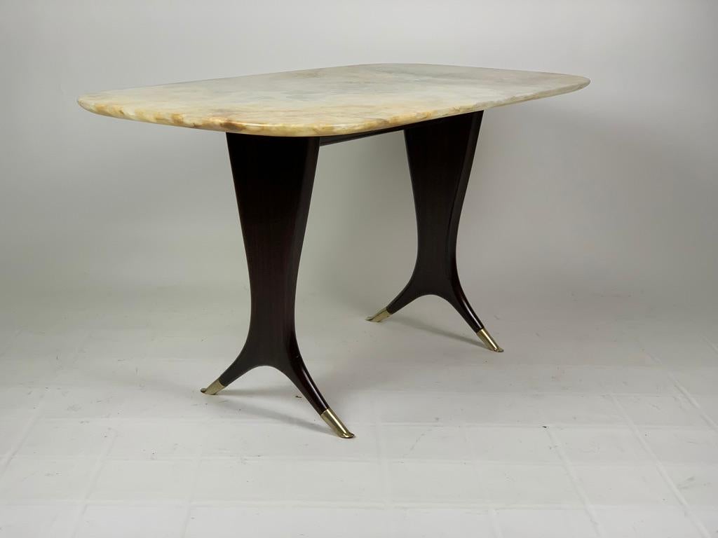 Coffee table for living room or sofa with thin legs and tips in cast brass, top in beautiful light onyx.
Attributable to Guglielmo Ulrich Italy 1950's. 
 