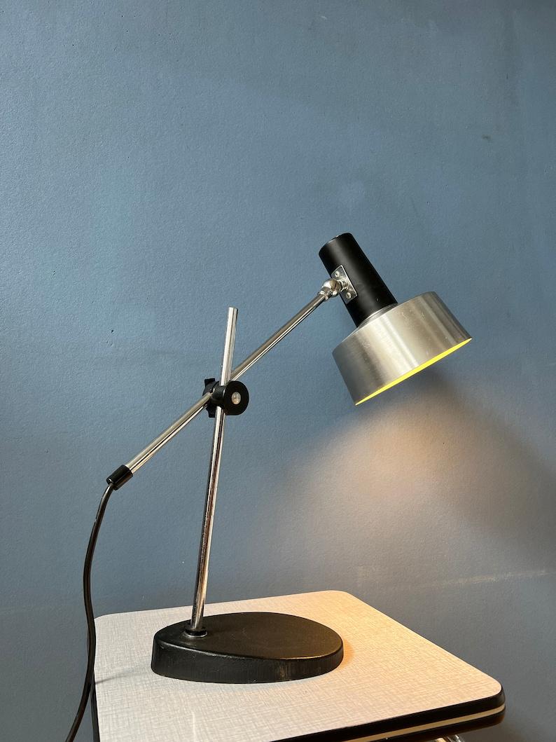 Mid century table lamp by Hala Zeist. The piece has a black, stone base and a flexible extendable arm and shade. It requires an E27 lightbulb and currently has an EU-plug (works outside EU with different plug or plug-converter).

Additional