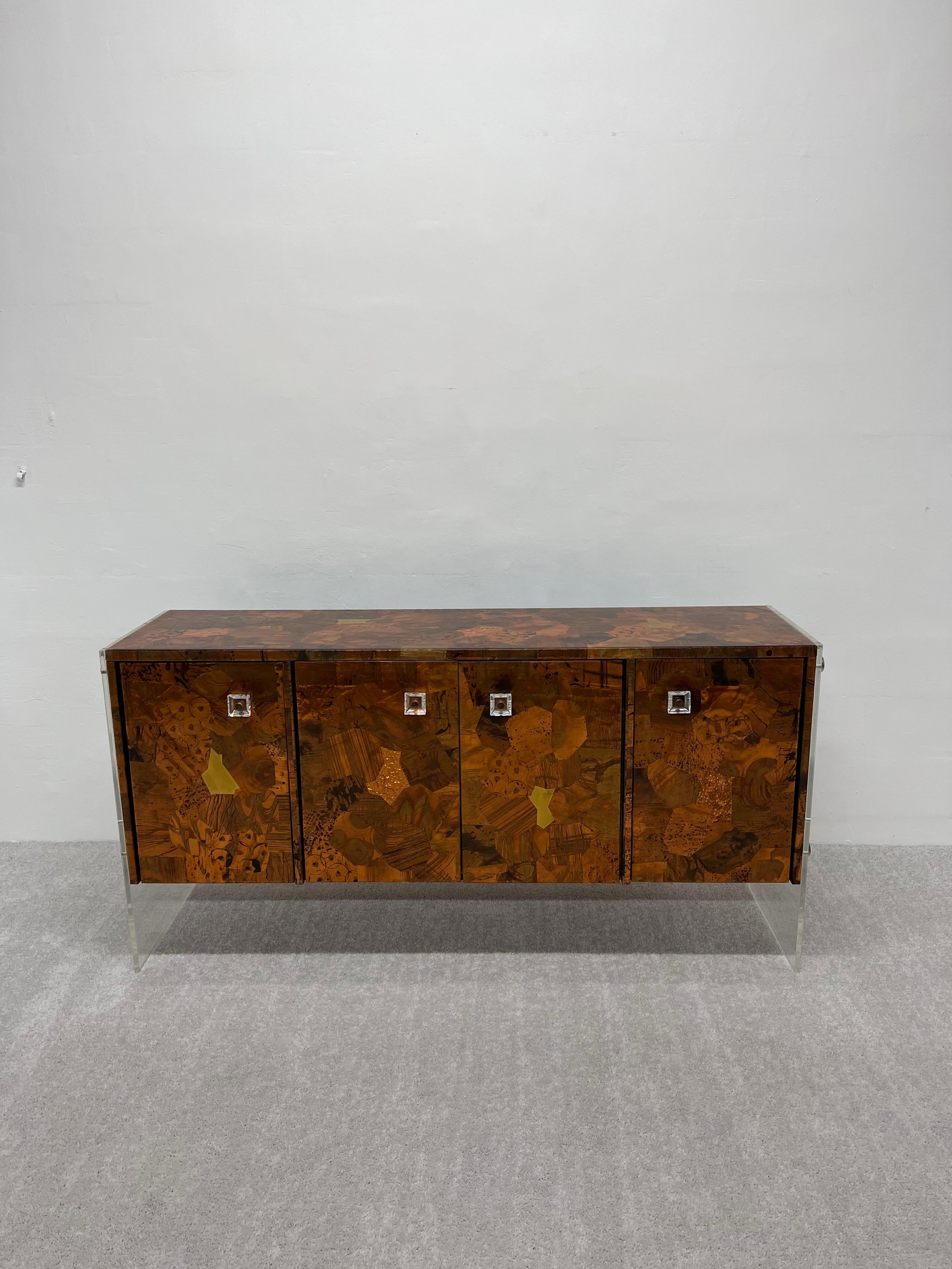 Floating sideboard made of hammered copper over wood with a hard resin coating and suspended from two pieces of lucite on each end. This modern statement piece shares similar qualities to Paul Evans and Milo Baughman era furniture designs. The door