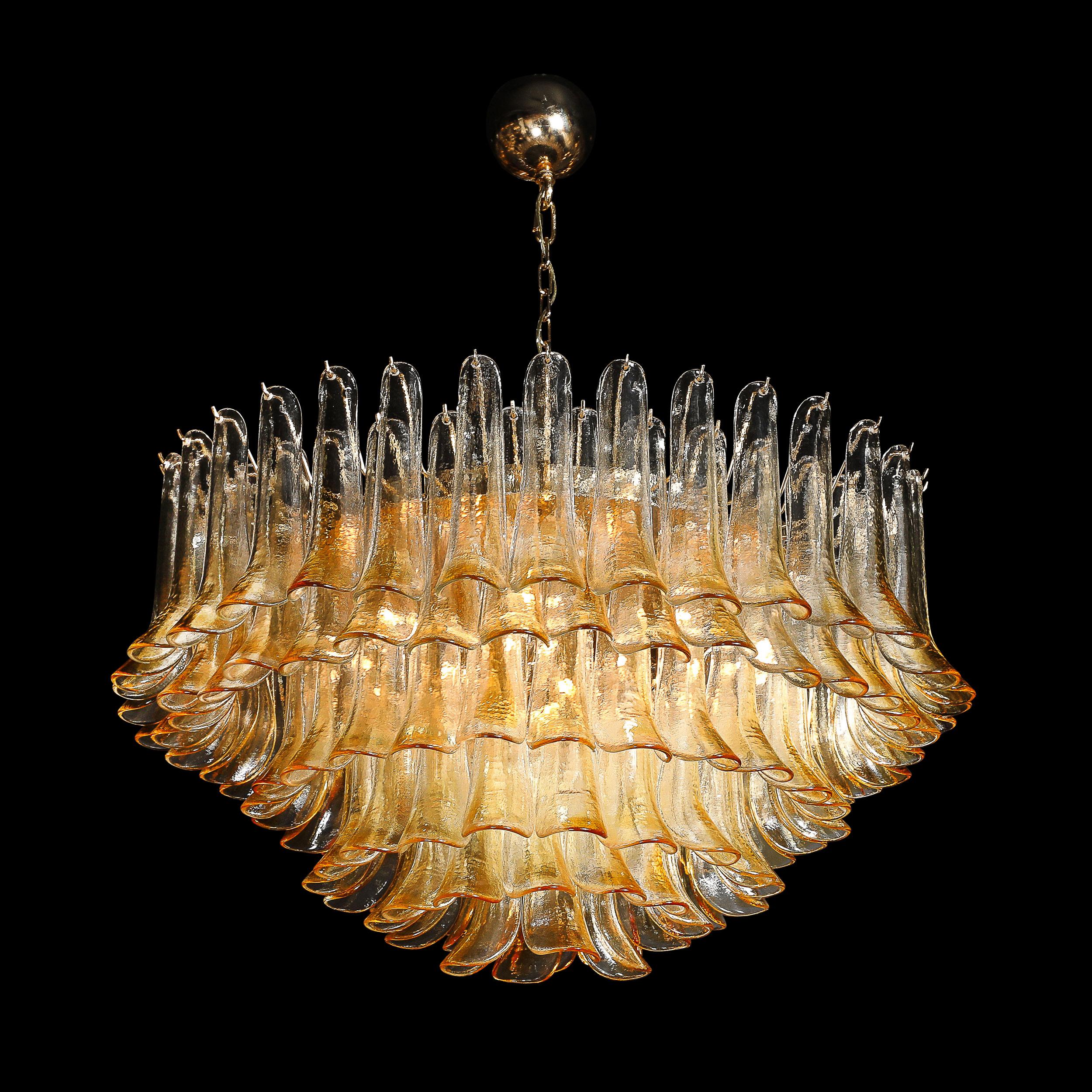 This remarkable Mid-Century Modernist hand-blown Murano feather glass chandelier, designed by the renowned Mazzega, hails from Italy circa 1980. The chandelier features an array of exquisite amber-colored Murano glass feathers, each meticulously