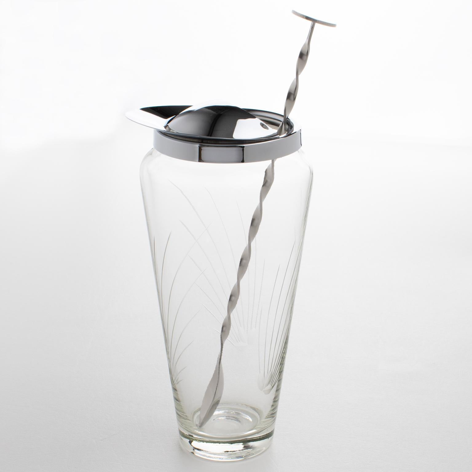 This exquisite, streamlined Mid-Century barware pitcher was crafted in France circa 1950. The sleek modernist design features a hand-blown Martini pitcher or mixer jug and a long stirrer spoon. The pitcher's crystal body has an etched line pattern