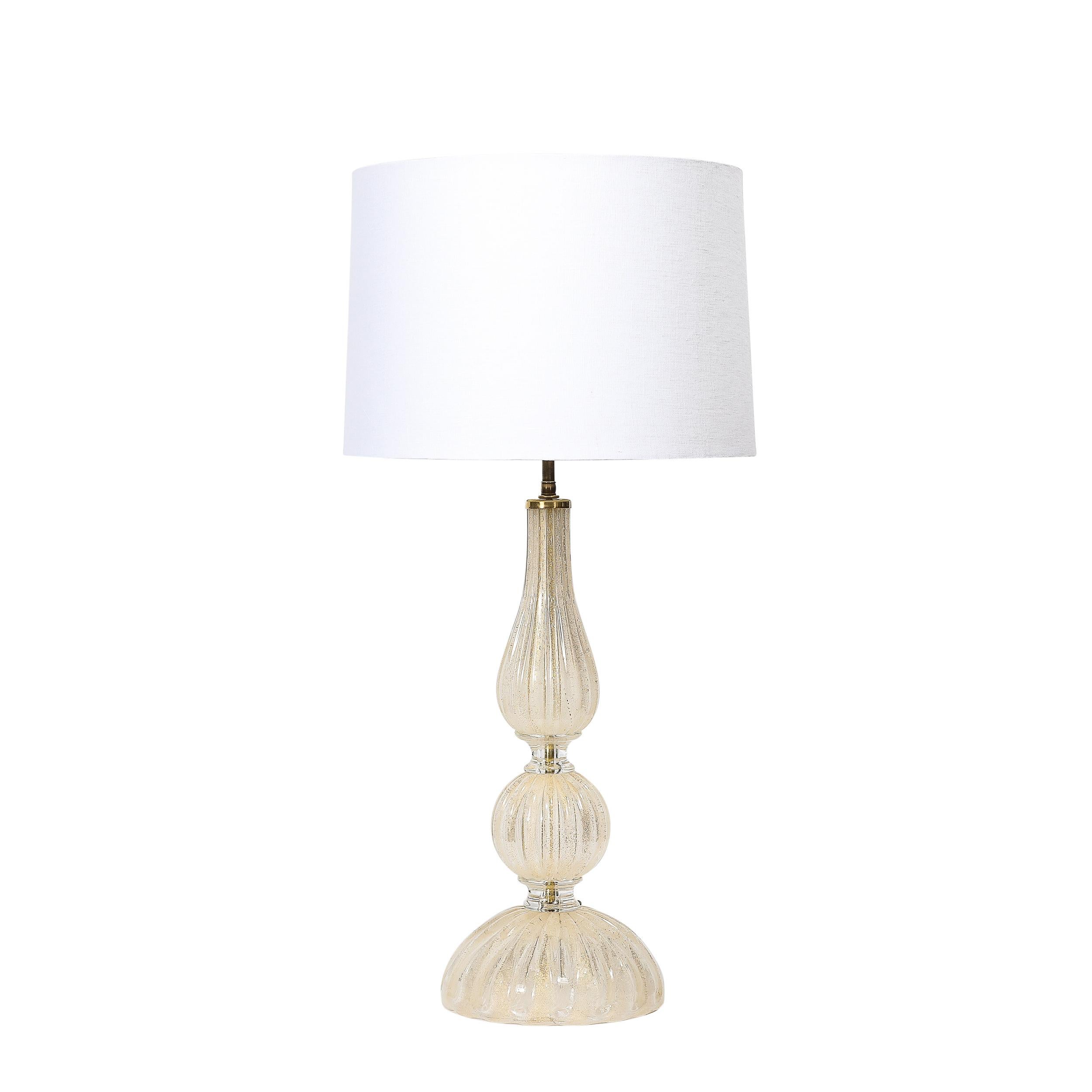 These exquisitely formed and balanced Mid-Century Modernist Hand Blown Murano Glass Table Lamps W/ 24K Gold Flecks & Brass Fittings by Seguso Vetri d'Arte originate from Italy, Circa 1970. Featuring a body composed of three primary elements of