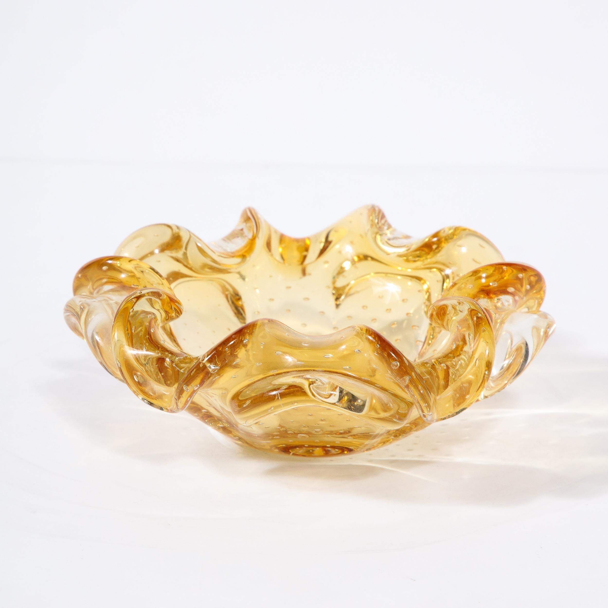 This dynamic and elegant Mid-Century Modernist Hand-Blown Murano Glass Dish in Citrine with Murine Detailing originates from Italy, Circa 1950. Coming from the Island of Murano Italy known throughout the centuries for glass work of the highest