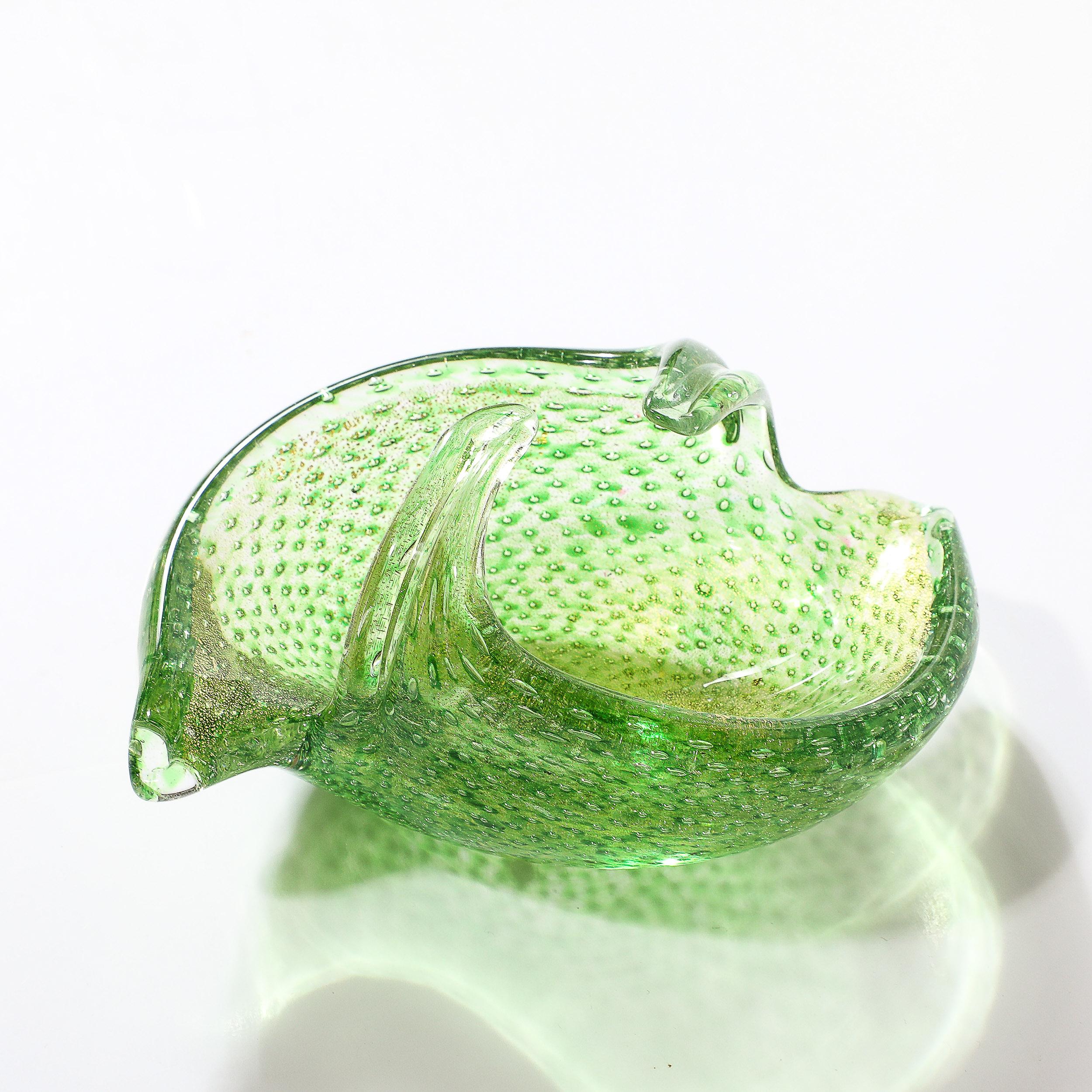 This dynamic Mid-Century Modernist Hand-Blown Murano Glass Dish in Lime Green with Bullicante Detailing & 24Karat Gold Flecks originats from Italy, Circa 1960. Featuring a sprial form with elongated arms bending in and out, this dish is well