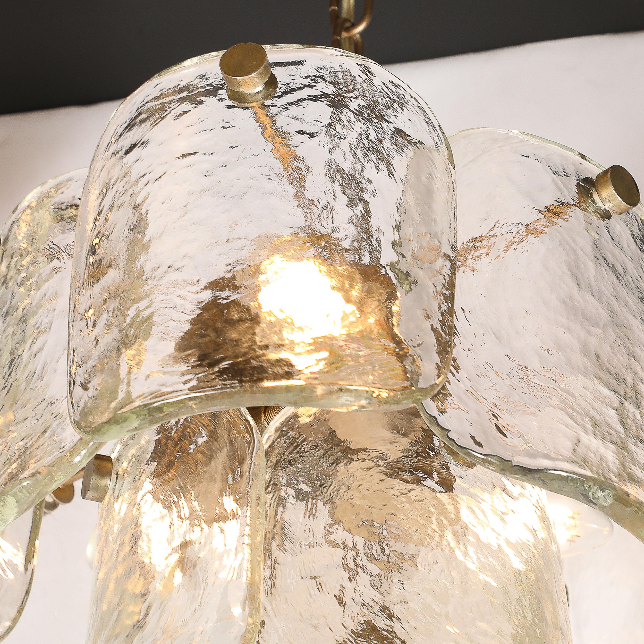 This stunning mid-century modernist pendant light, crafted by the renowned Mazzega glassworks in Italy circa 1960, features exquisite hand-blown Murano glass complemented by matte bronze fittings. The pendant's elegant design showcases the