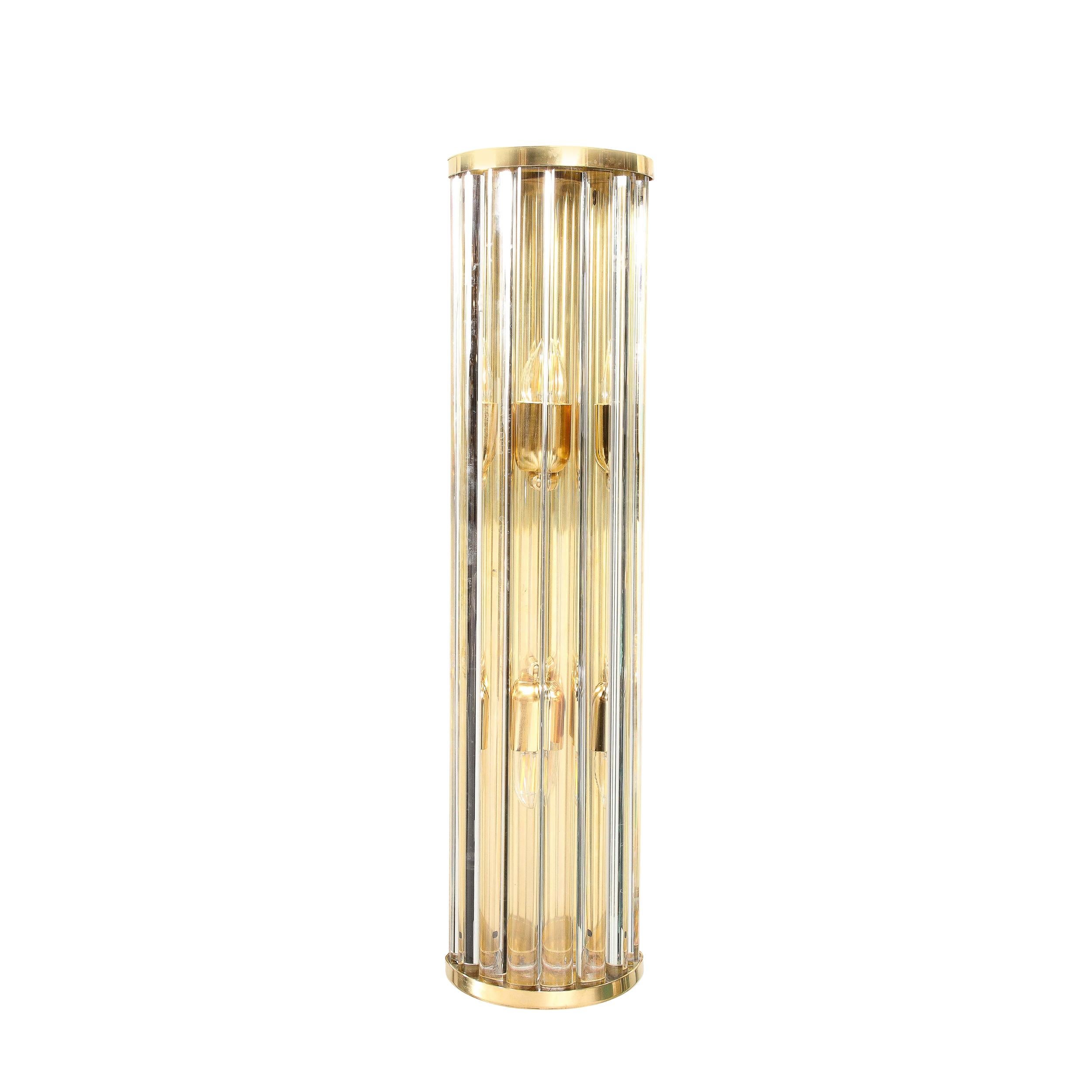 This Pair of Mid-Century Modernist Sconces in Glass Rods and Brass fittings were created by Toso Murano and originate from Italy during the latter half of the 20th Century. Featuring gorgeous translucent glass rods in a curved demilune frame in