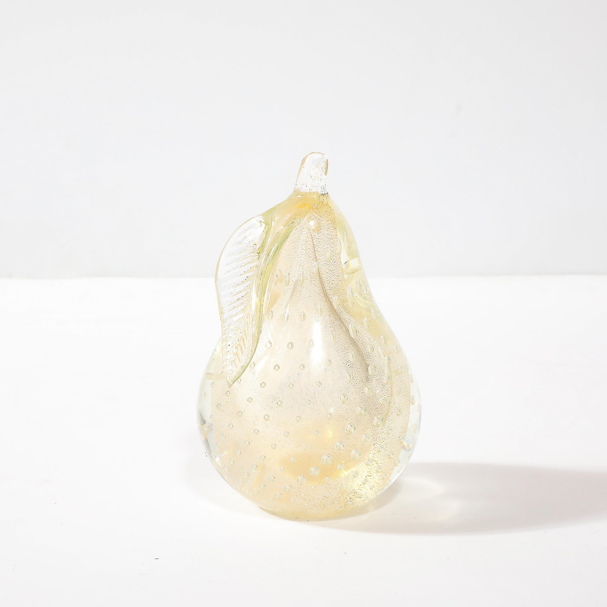 This stunning Mid-Century Modernist hand-blown Murano glass pear, crafted in Murano, Italy circa 1960, is designed as a functional and elegant paperweight or decorative object Created from transparent glass, the piece is infused with 24-karat gold
