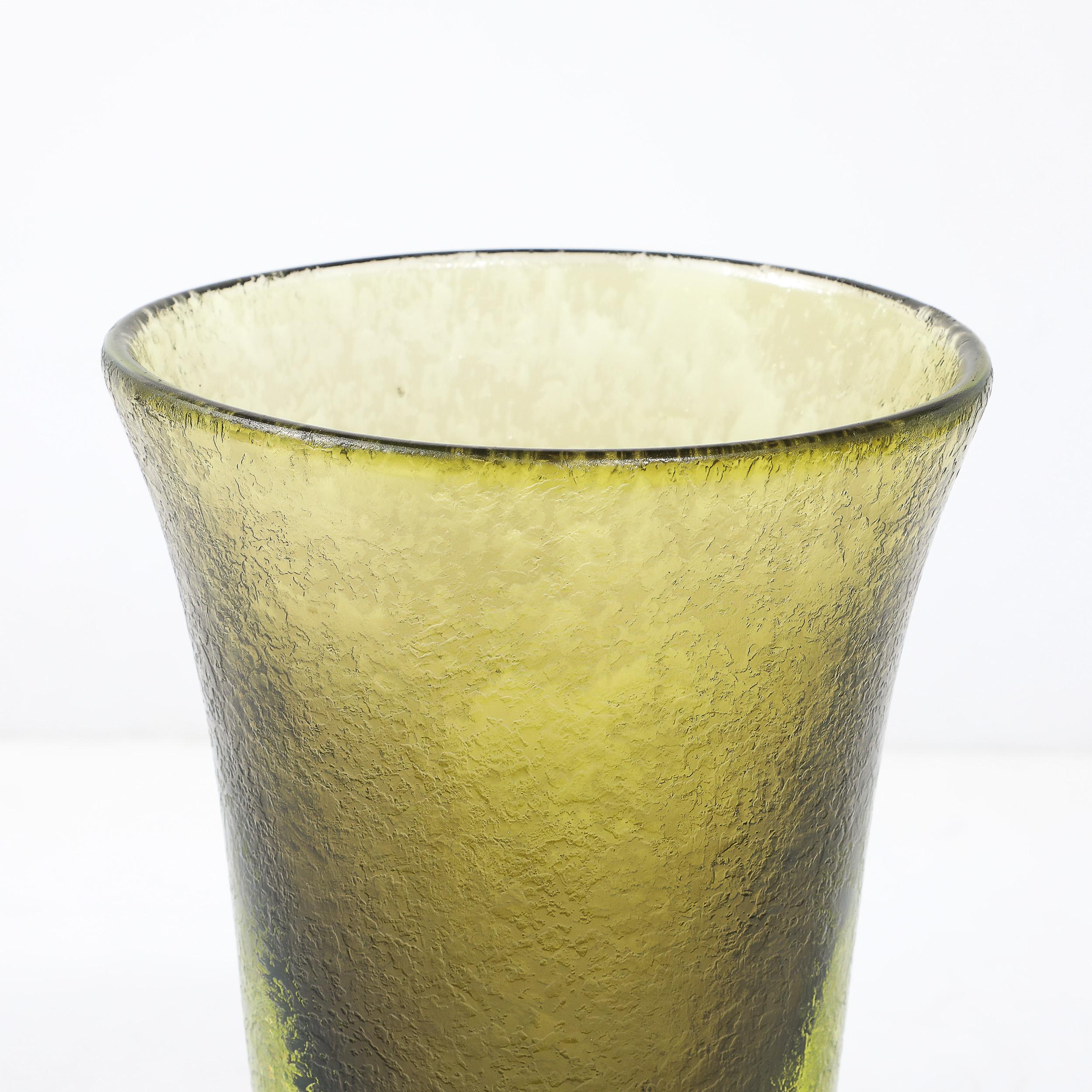 This exquisite Mid-Century Modernist vase showcases the unparalleled artistry of Murano glassmaking, crafted in Italy circa 1970. Hand-blown to perfection, the piece features two distinct bands of olive and lime green hues that radiate vibrancy and