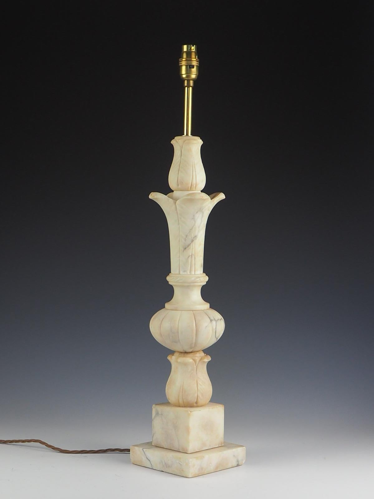 Italian Hand Carved Alabaster table lamp with beautiful shaped body, resting on a square platform base. Milky white alabaster with grey and gold veining.

Each section of this lamp has been carved individually and pieced together. 

Exquisite,