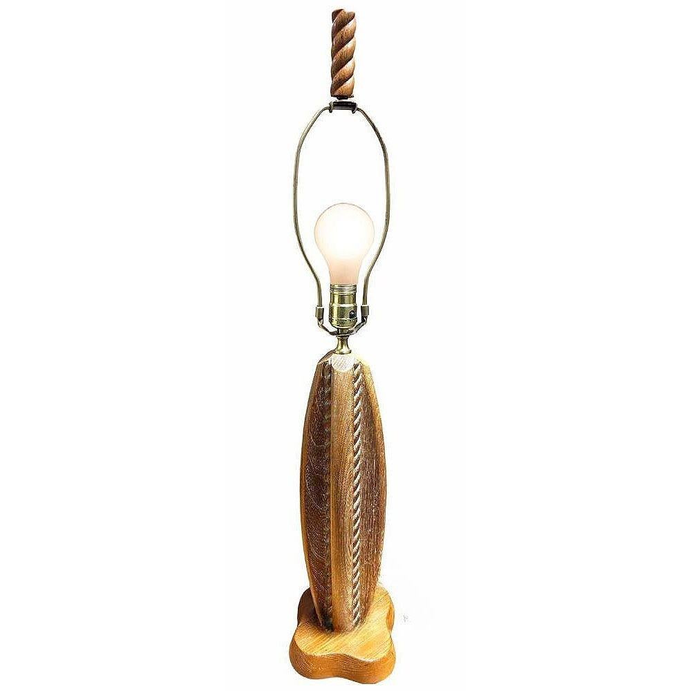 Mid-century Hard-carved abstract maple wood table lamp in the style of Yasha Heifetz. It showcases a striking four-sided design, each panel adorned with indented rope-like patterns. The warm, natural wood tones enhance its form, reflecting the clean