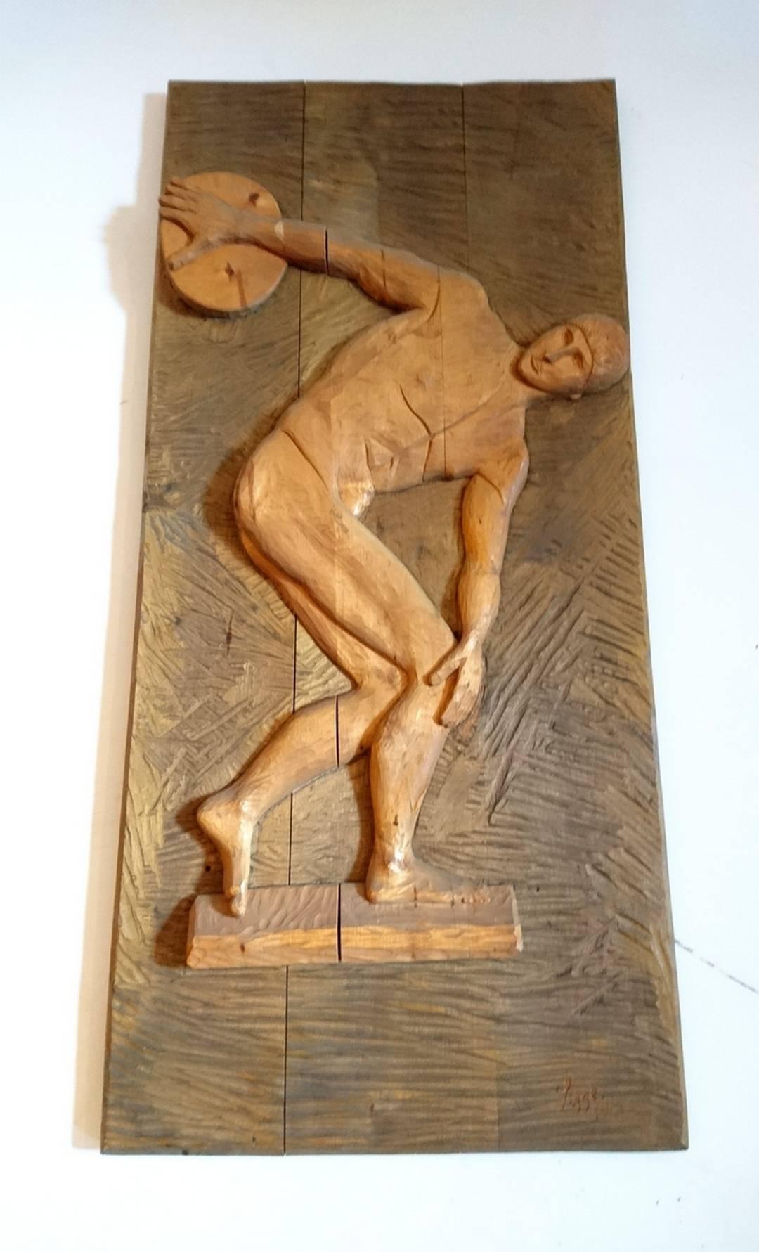 Hand carved large panel portraying a discus thrower, Signed 