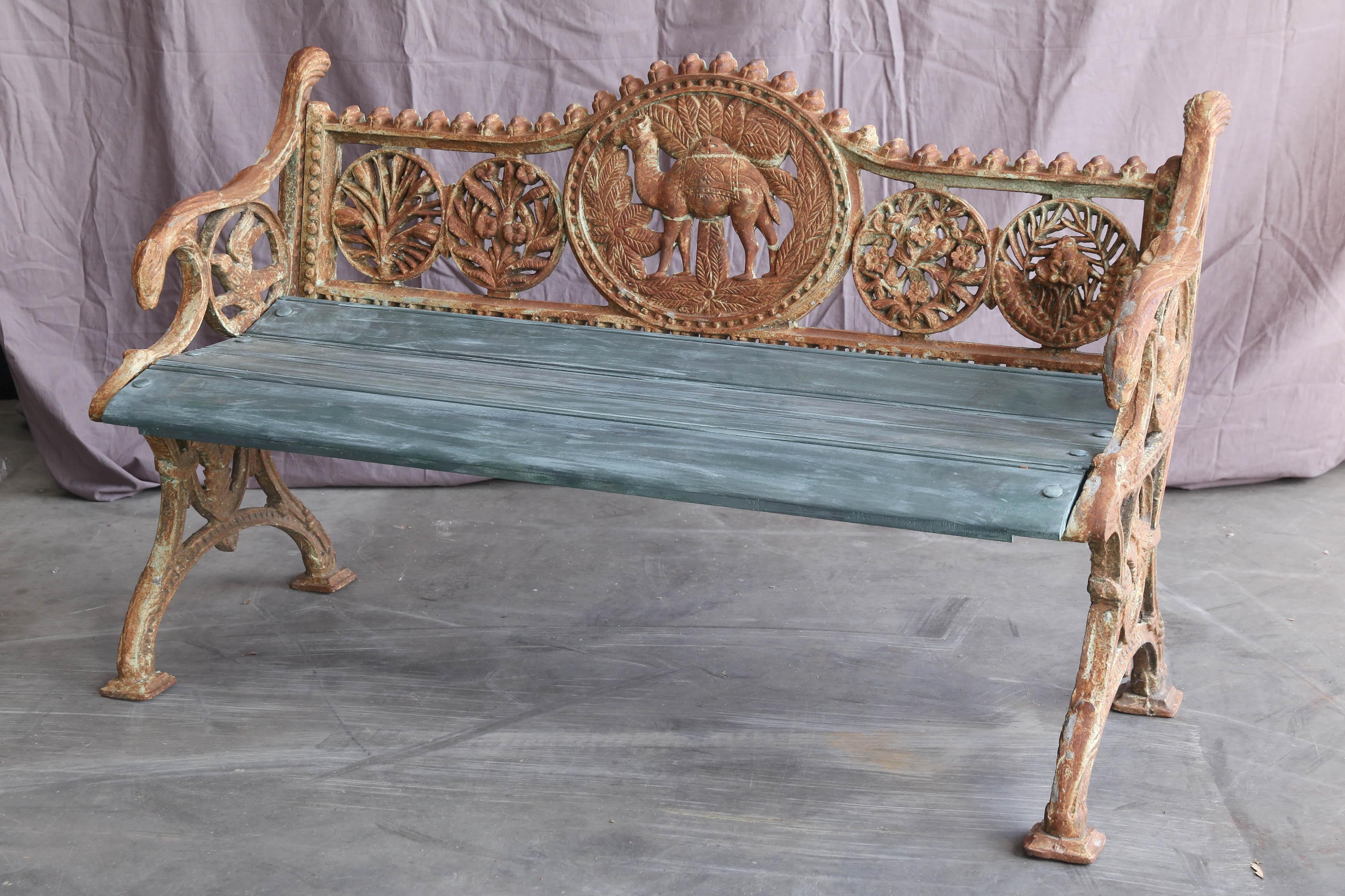 Benches like these were cast in old foundries in Calcutta and were extensively used in colonial rail road stations. The wooden seats would be replaced when the seats were worn out. This one has a camel emblem indicating that it comes from a railroad