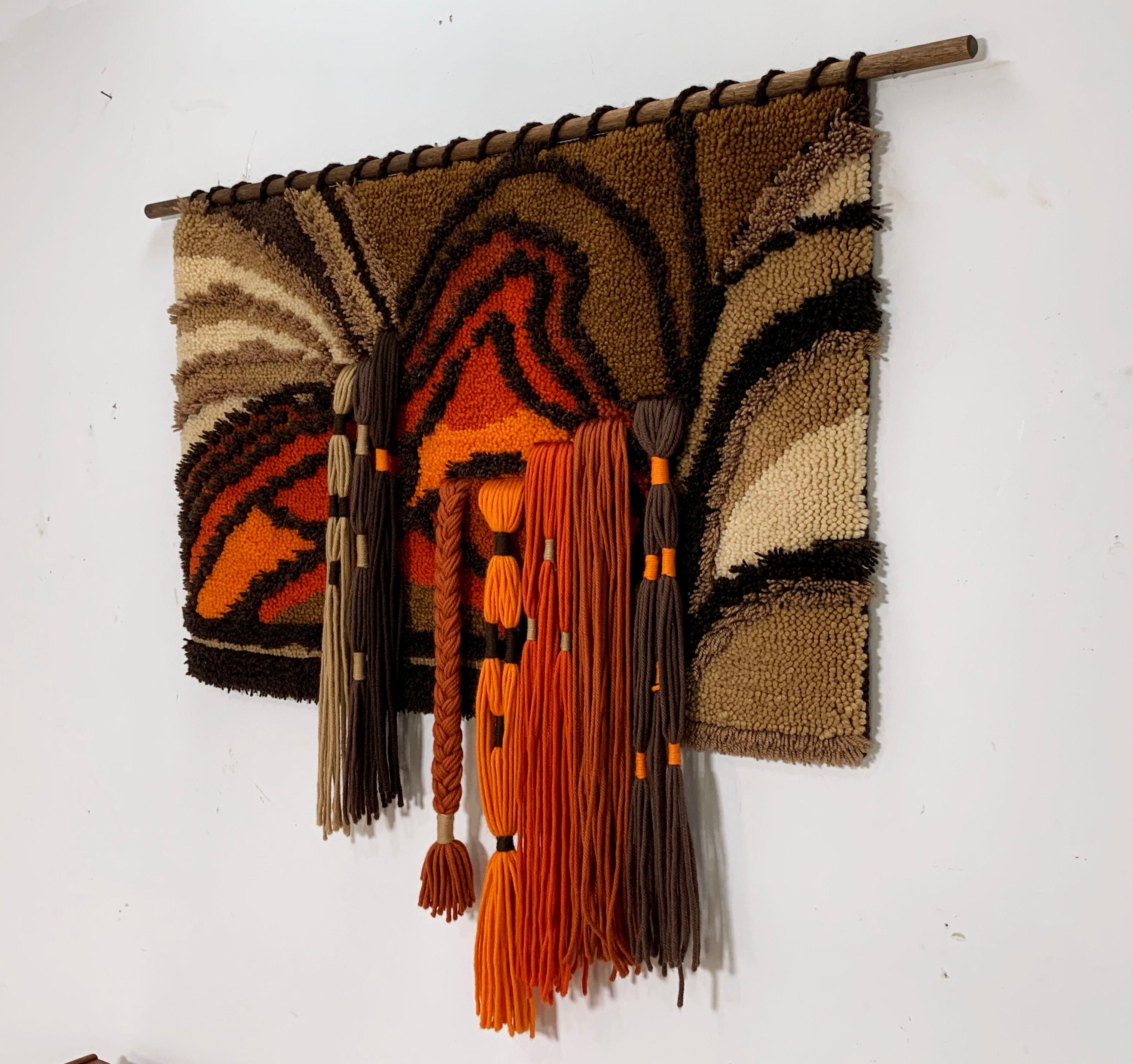 An artist crafted midcentury hand worked yarn weave textile wall hanging, circa 1970s. A wonderful example of 1970s era craft, with colorful dimensionality.
Textile measures: 44