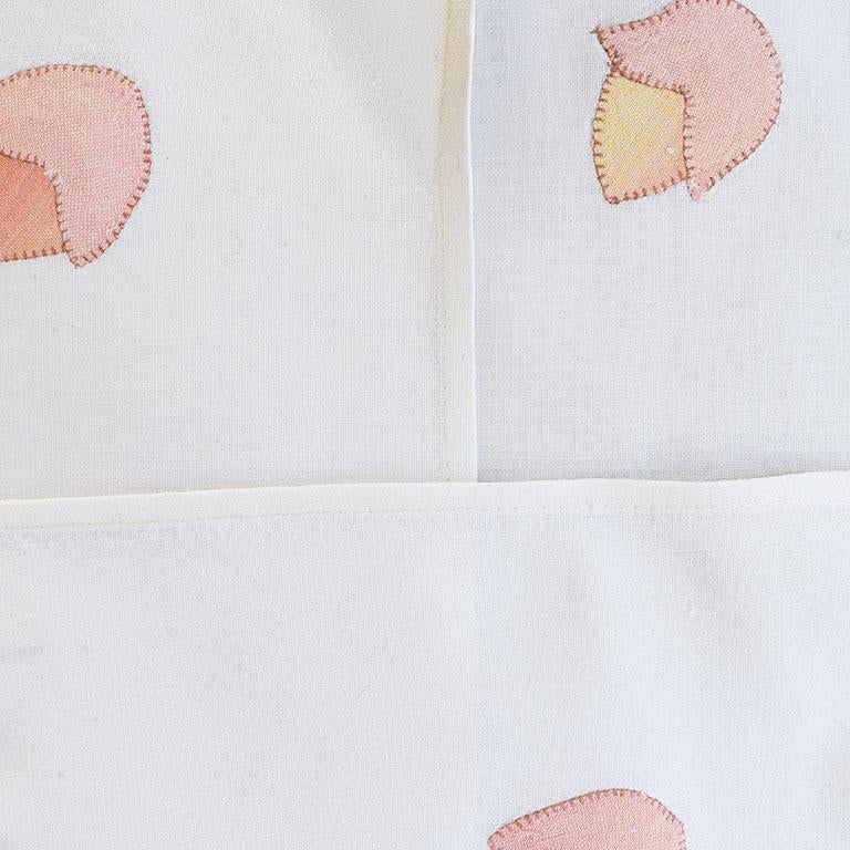 A set of crisp white dinner or cocktail napkins with hand-embroidered pink flowers. A wonderful set of seven napkins. Each is square and features an applique ombre pink, peach, and yellow flower embroidered into the corner. 

Dimensions:
15