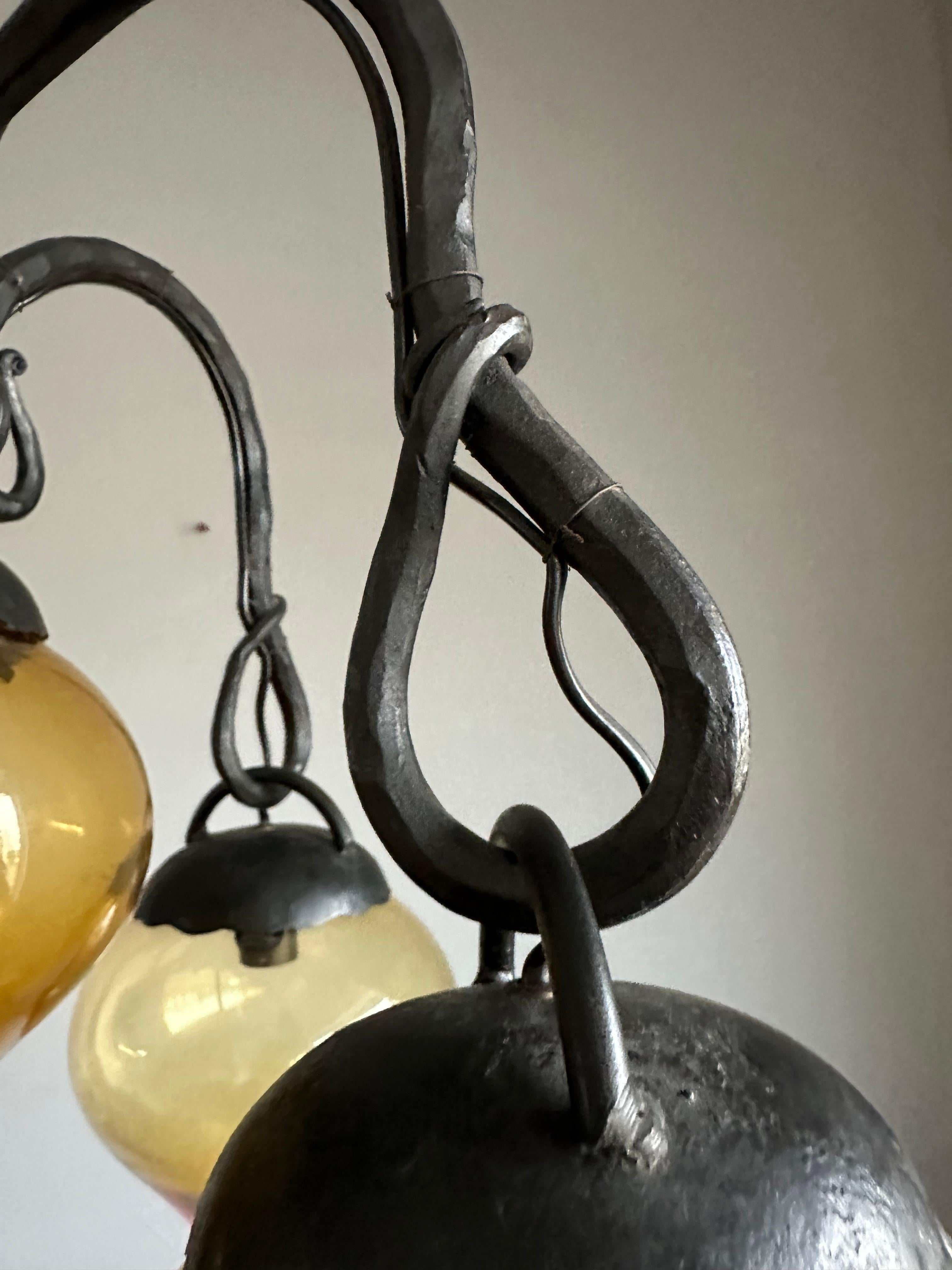 Lustre en fer forgé du milieu du siècle, forgé à la main, avec. Cinq abat-jour en verre soufflé ambré en vente 11