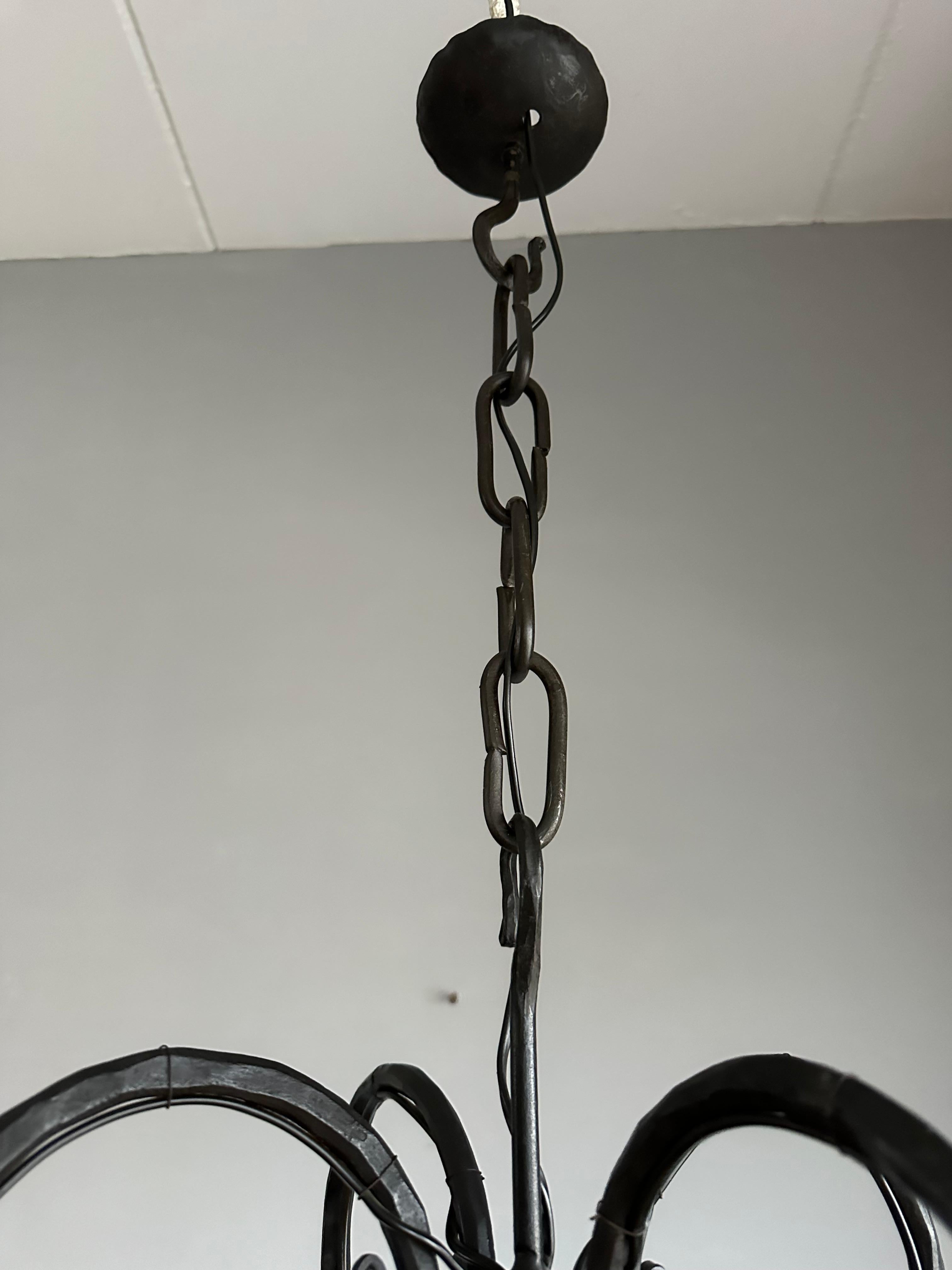 Lustre en fer forgé du milieu du siècle, forgé à la main, avec. Cinq abat-jour en verre soufflé ambré en vente 1