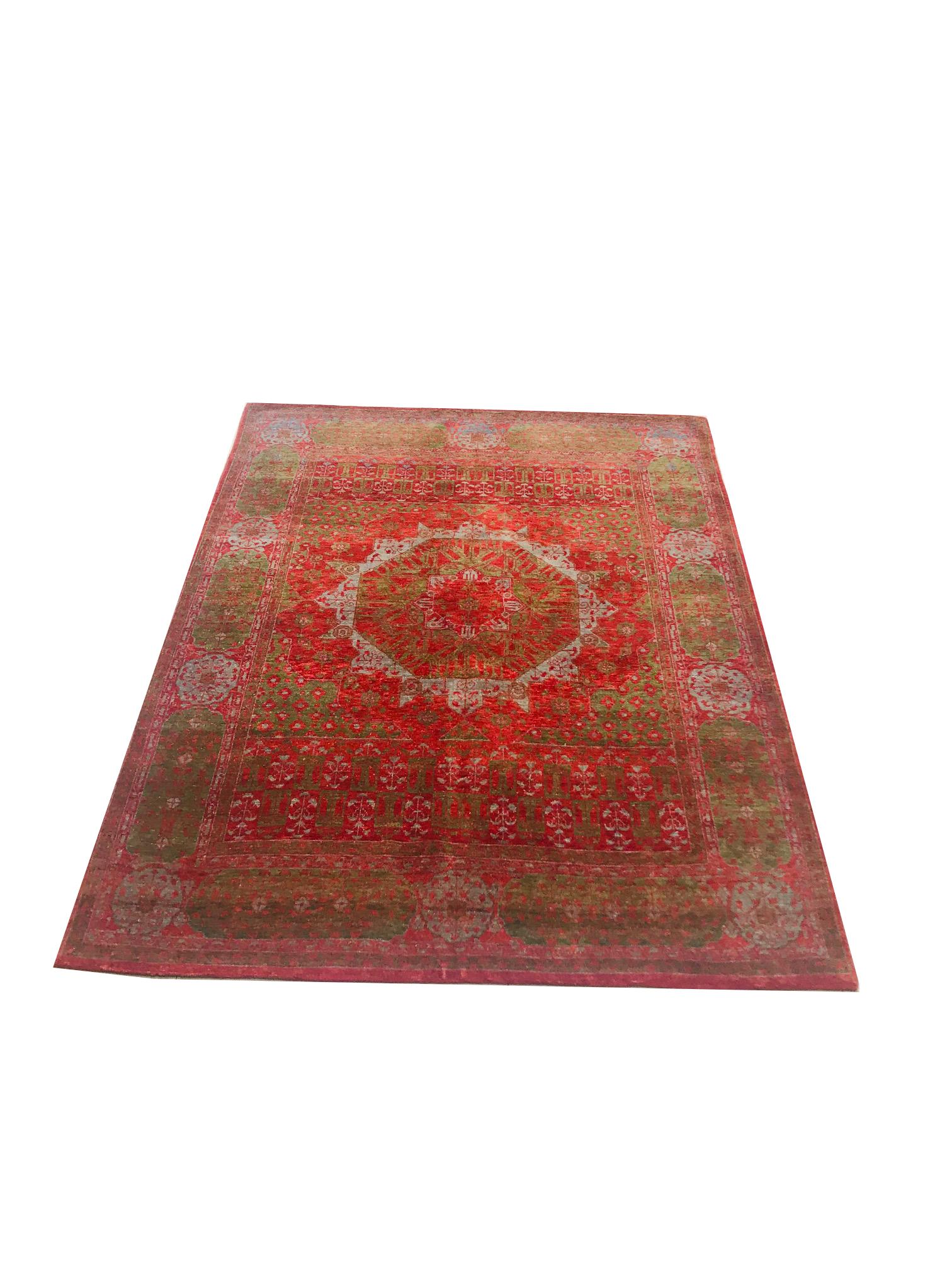 This is an elegant Egyptian rug, woven by hand with wool, made in circa 1950.

It is kept in perfect condition. It uses a combination of strong-colored flowers such as red and green that support the sophisticated central floral medallion.
This