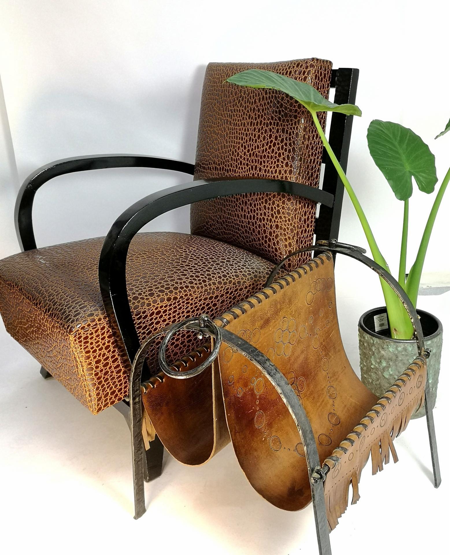 This hand made cow leather and wrought iron magazine holder was made in the 1970's- and is in great condition. The leather has no rips or tears, the wrought iron is in good condition. Very decorative piece for any home!