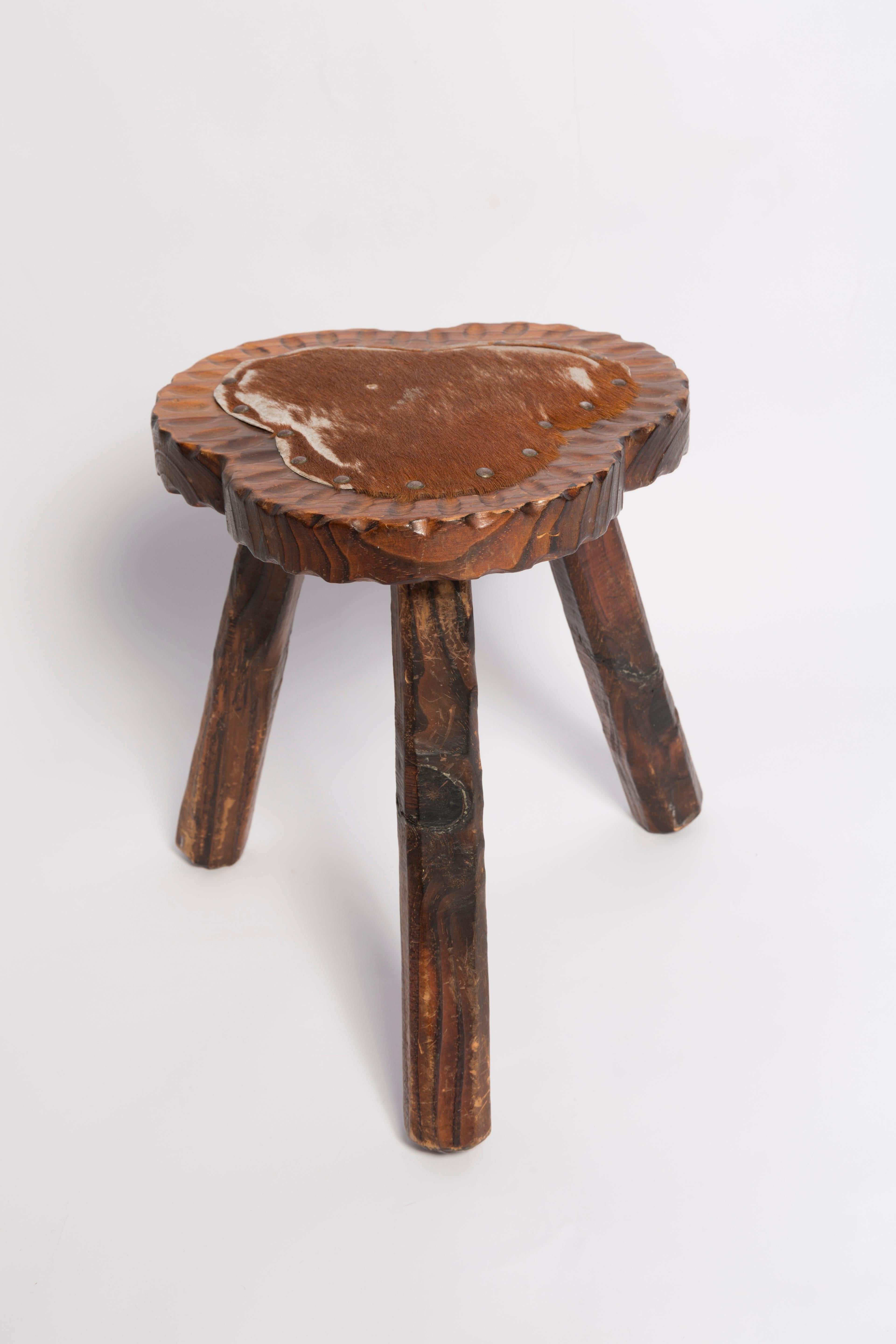 Stool from the turn of the 1960s. Cow fur on the seat. The stool consists of an upholstered part, a seat and wooden legs narrowing downwards, characteristic of the 1960s style. The stool is original very good vintage condition. Only one unique piece.
