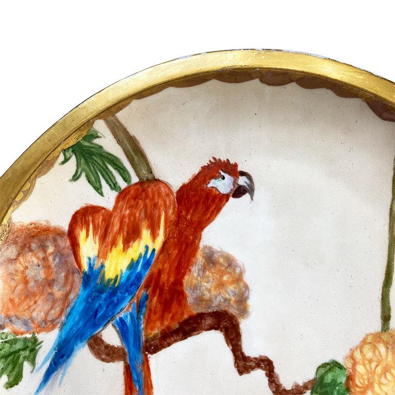 A beautiful Mid-Century Modern decorative serving platter. Perfect for adding a little pop of color to any table setting, this piece by Lorenz Hutschenreuther is hand painted with a scene of a colorful parrot amidst a jungle background with