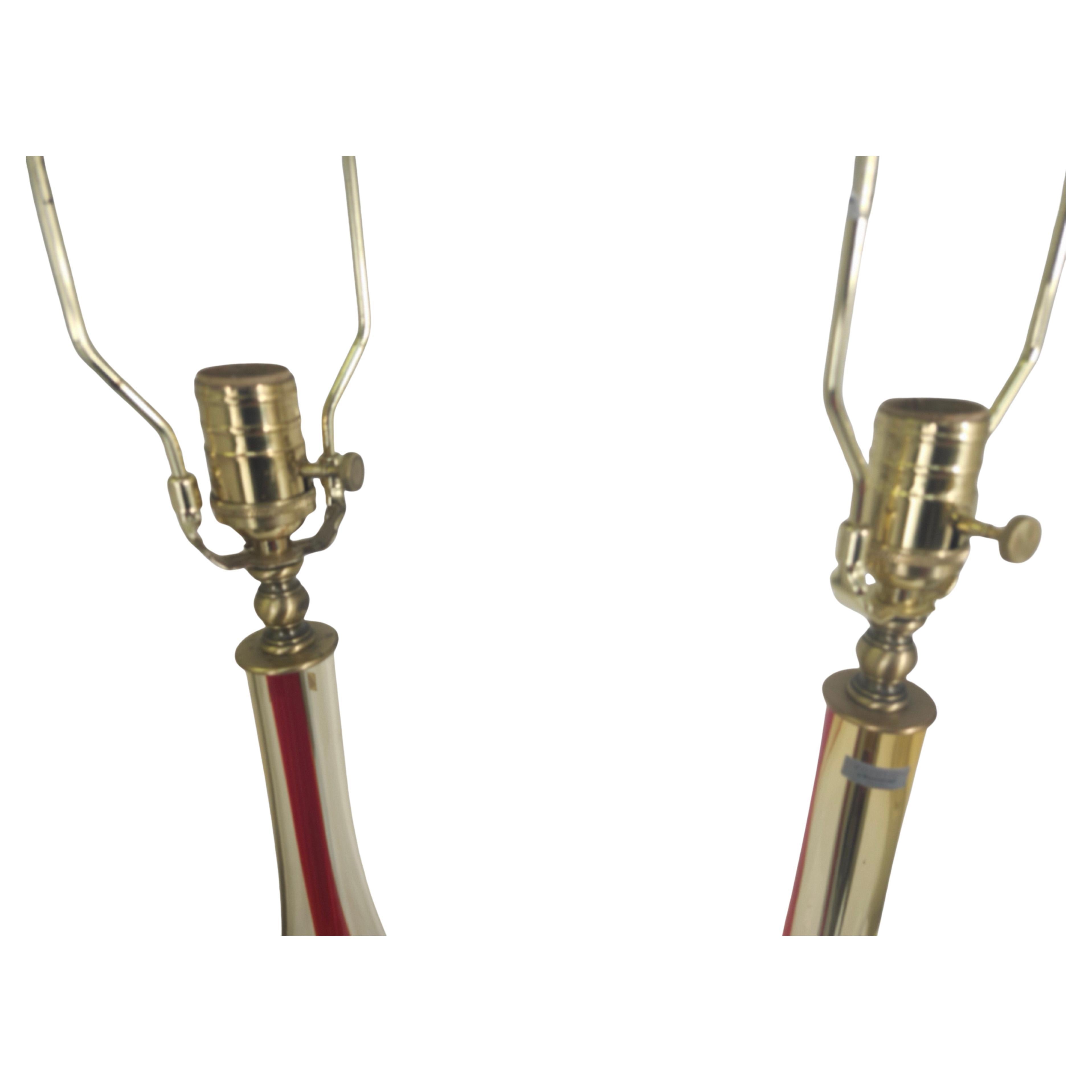 Spectacular pair of Art Glass table lamps by Waterford. Evolution is the name given to them, made in Poland.Red and yellow swirling from the base to the top with brass hardware. Hand blown and in excellent condition. Priced and sold as a pair.