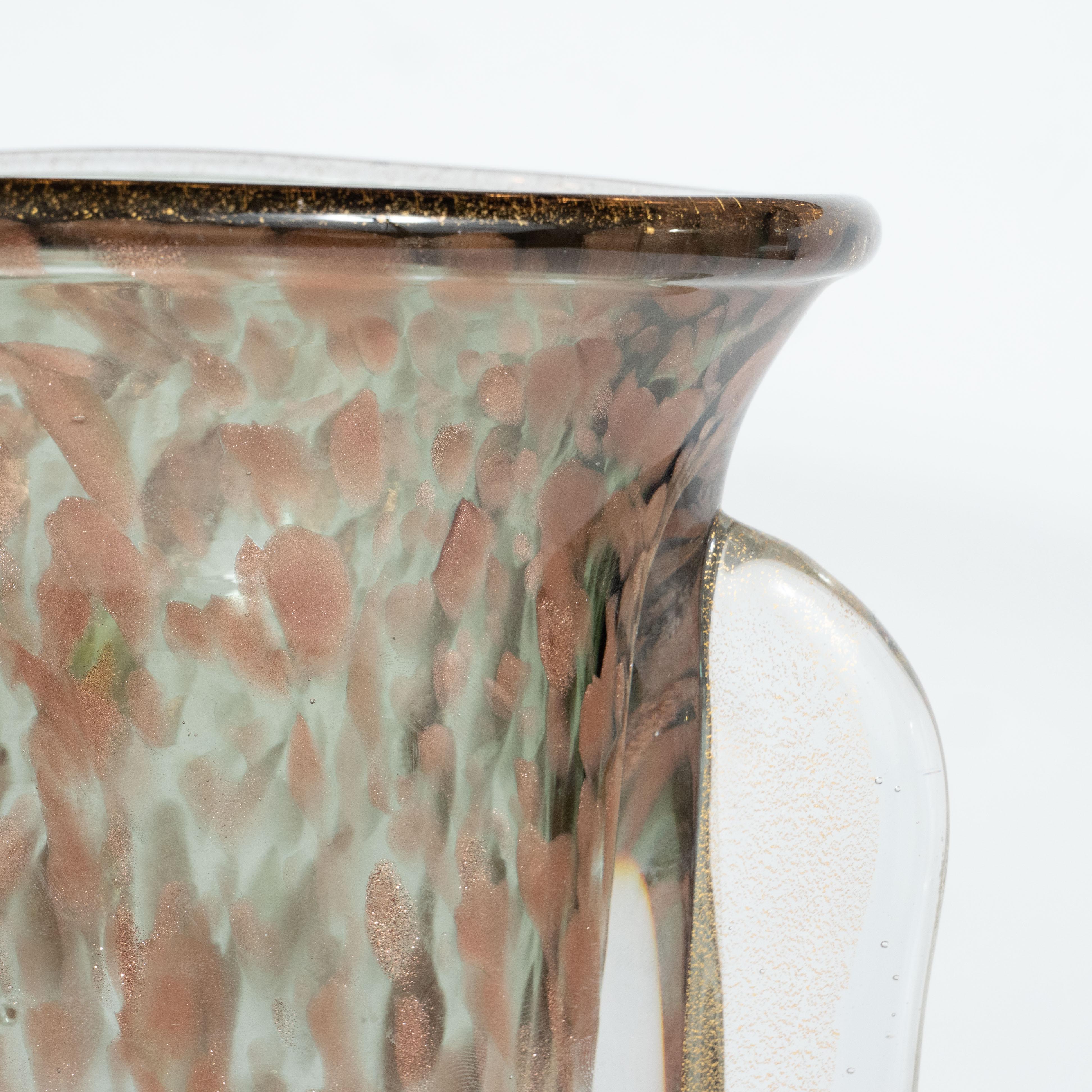 This gorgeous Mid Century Modern vase was realized by the fabled atelier, Vistosi, in Murano Italy- the island off the coast of Venice renowned for centuries for its superlative glass production- circa 1960. Featuring an urn form body with curved