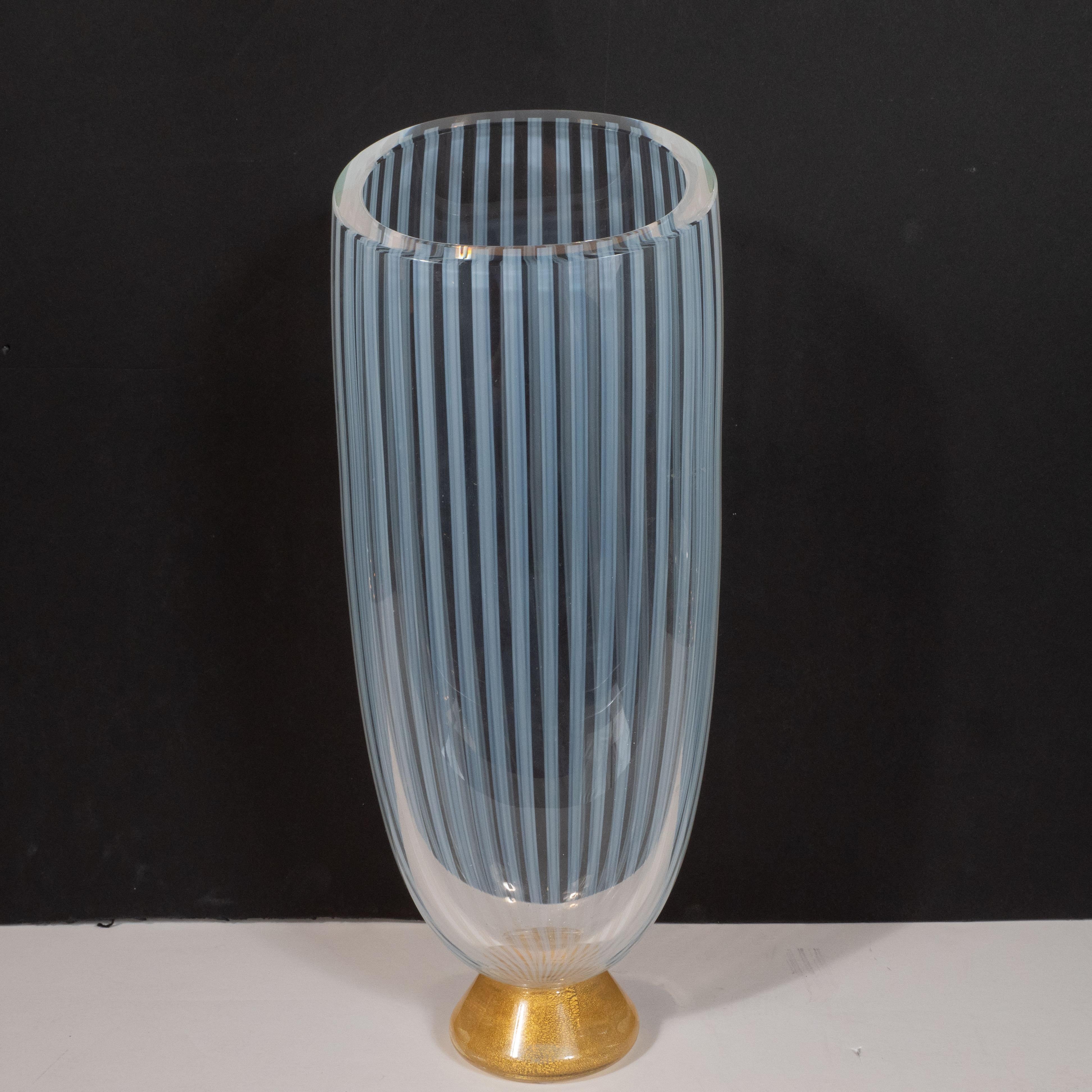 This stunning Mid-Century Modern vase was realized by Seguso- one of the most renowned glass ateliers of the period- in Murano, Italy, circa 1960. It features an hourglass form with a conical base replete with an abundance of 24-karat gold yellow