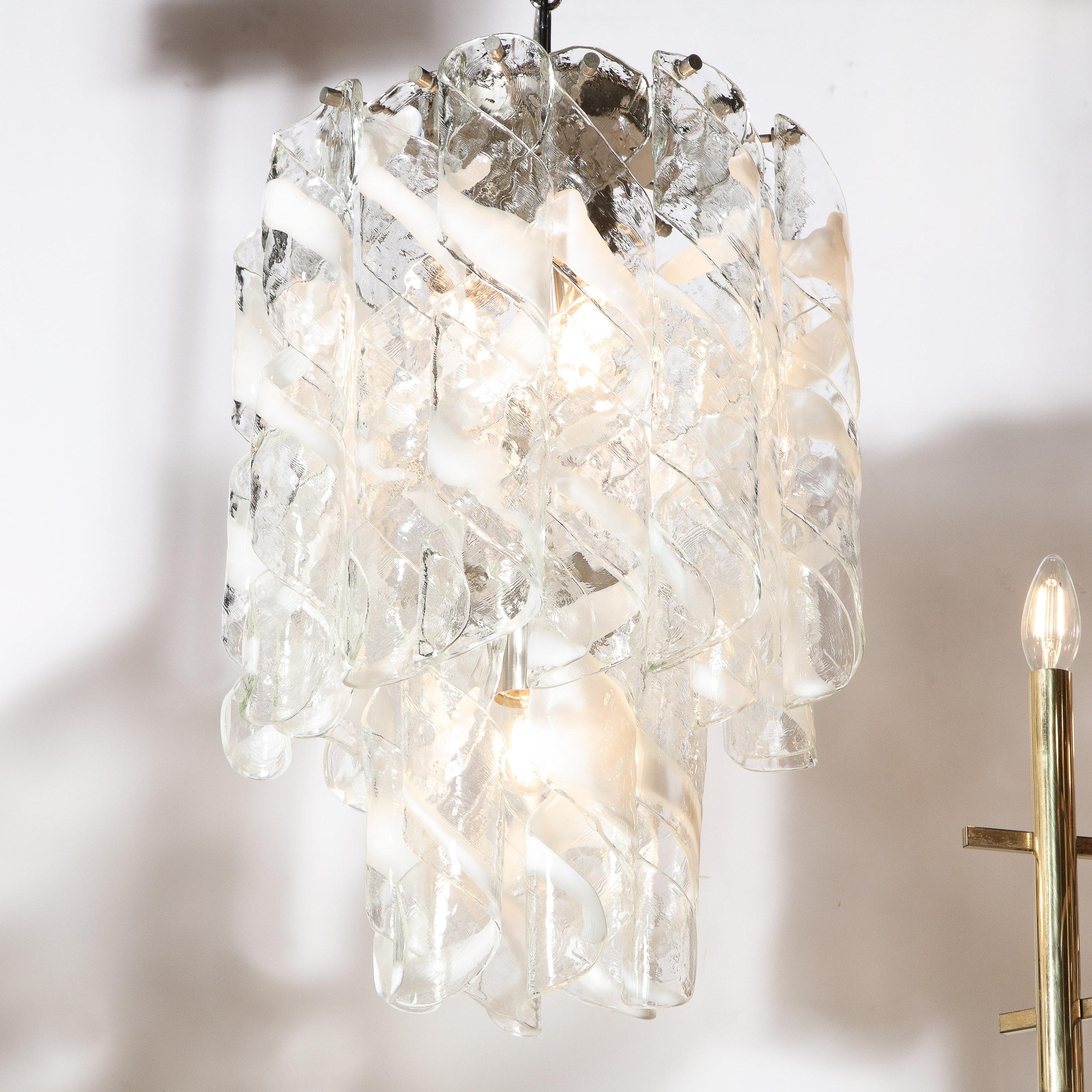 This bold and refined Mid-Century Modern chandelier was realized in Murano, Italy- the island off the coast of Venice renowned for centuries for its superlative glass production, circa 1970. It features a wealth of cylindrical helix form shades in