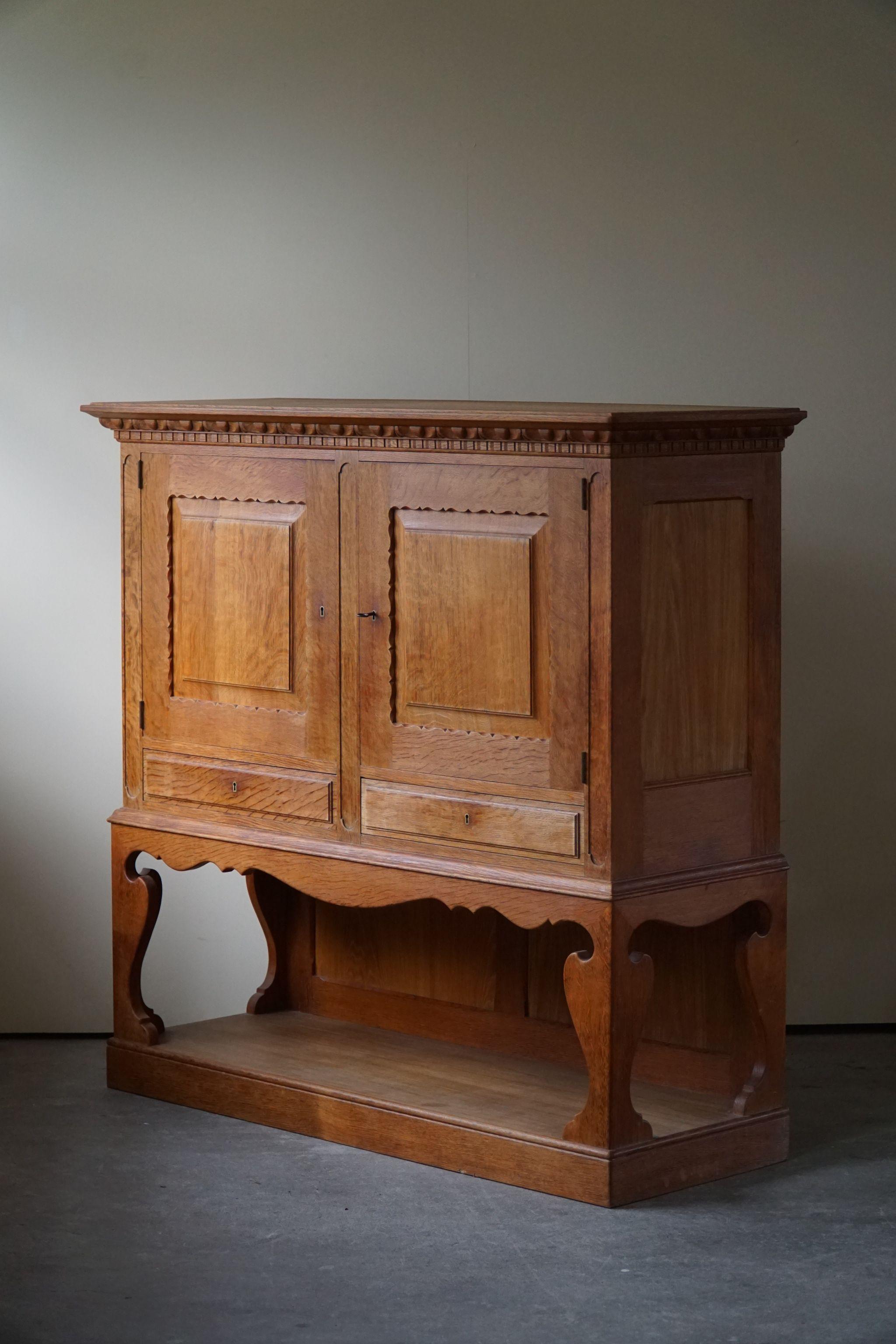 A beautiful handcrafted cabinet - perfect storage furniture for the living room with space for your art and books.
The cabinet is made of high-quality oak in the 1940s by a Danish cabinetmaker. This piece is in a great vintage condition, with few