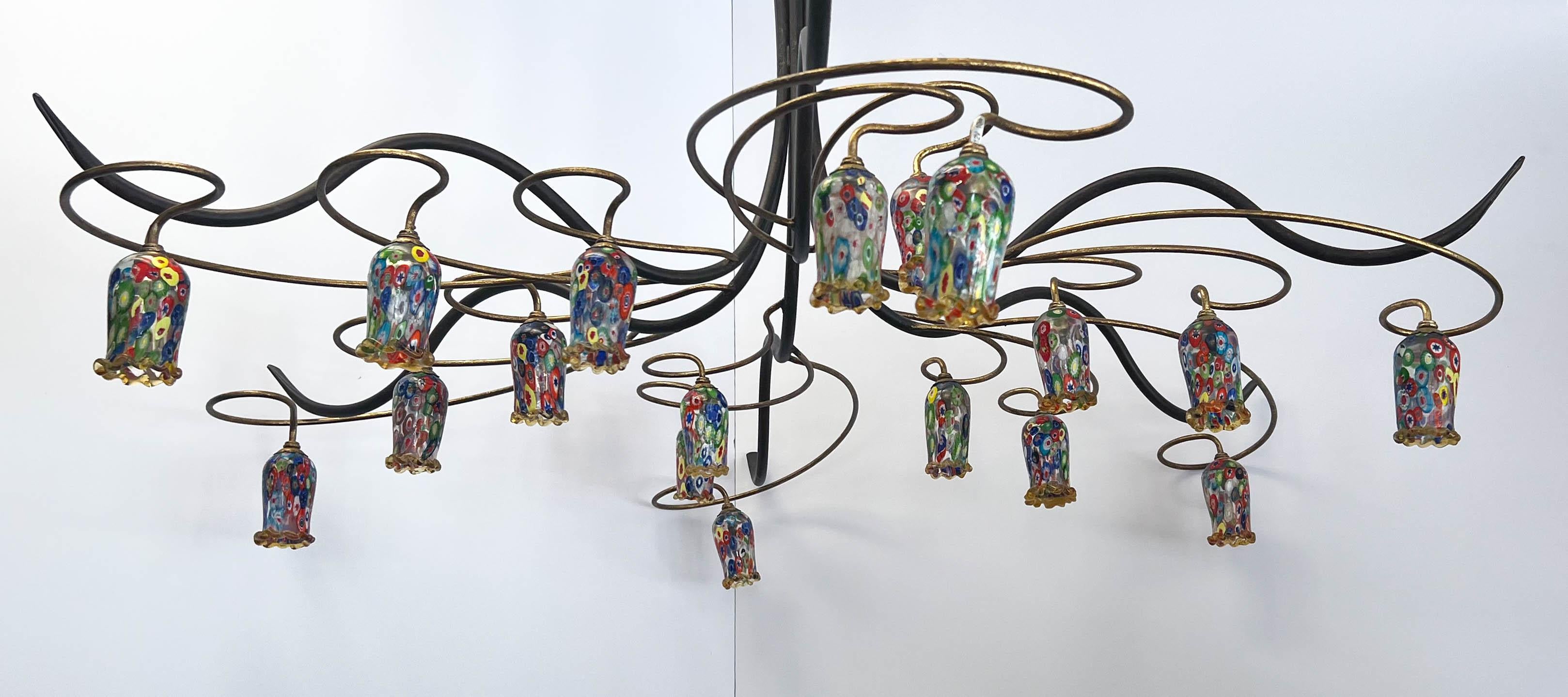 A one-of-a-kind hand-crafted Mid-Century iron and copper six-arm chandelier. Each arm has three scroll-shaped copper twigs from which hangs suspended a Millefiori, Murano/Italy glass cup.