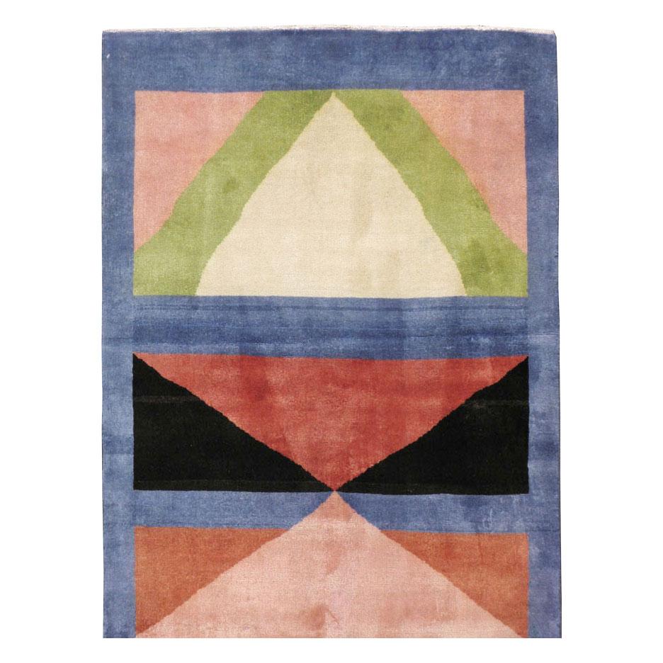 A vintage Persian Kashan Art Deco rug handmade in runner format during the mid-20th century. The modern deco style design is inspired by Edward McKnight Kauffer and filled with shades of blue, light green, peach, nude and pink, ivory, and light