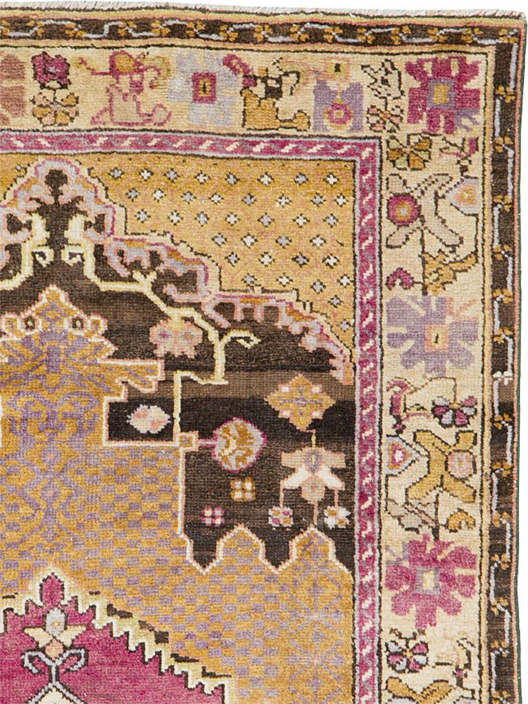 A vintage Turkish Anatolian rug from the mid-20th century. A plain dotted golden brown sub-field is set on a brown panel with a stiff vine and rosette pattern. The plain square dots are in an unusual greyish purple shade. The medallion displays an