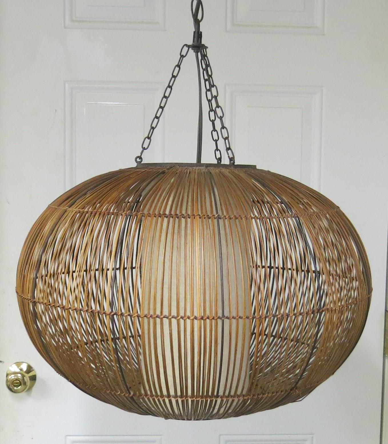 Midcentury hanging lamp rattan natural fiber. Good condition the oval shape is 20