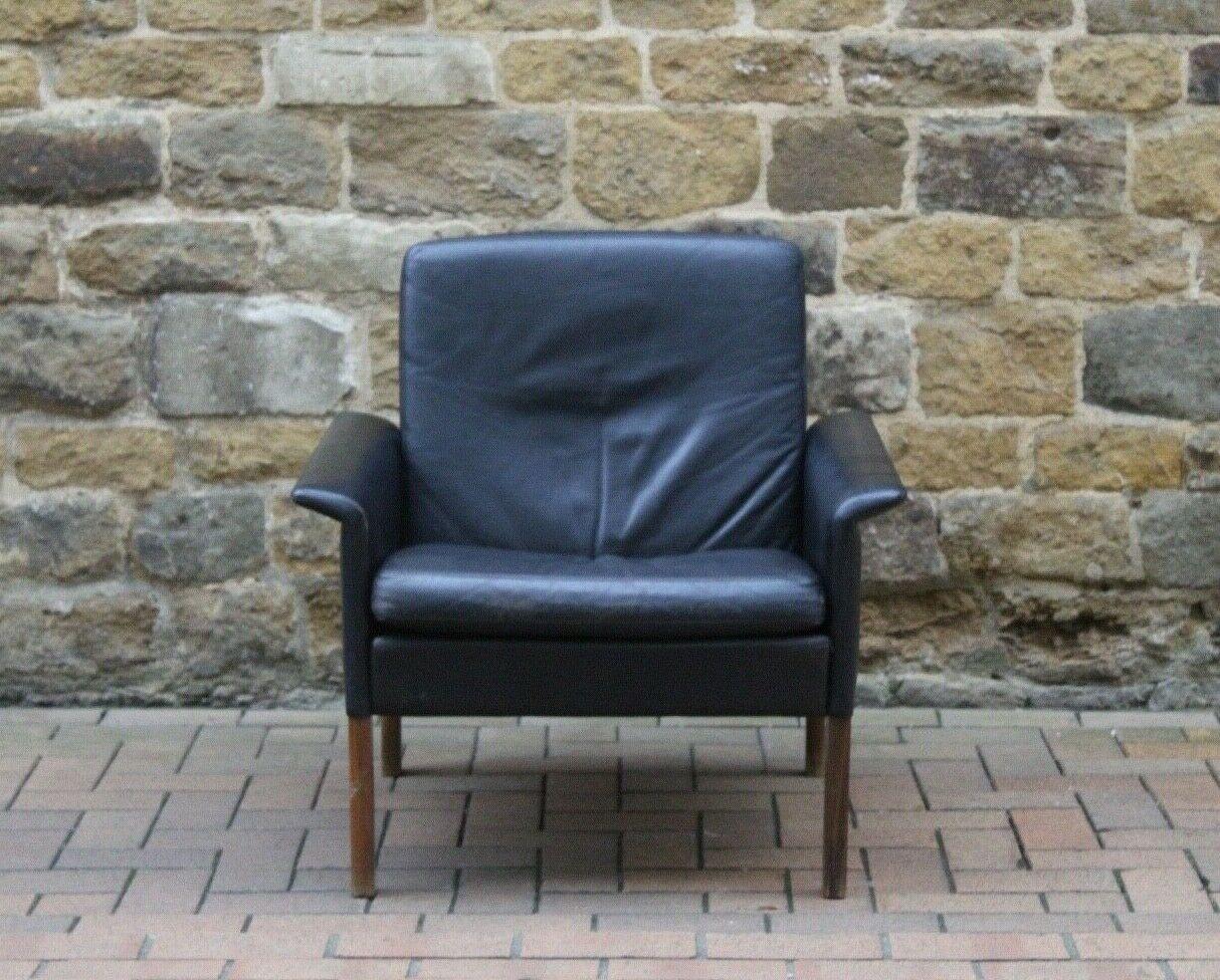 This is a very stylish and desirable rare black leather Danish armchair with rosewood legs by Hans Olsen.

Great original vintage unrestored condition and in its original upholstery. 

The made in Denmark logo is stamped on the underside of the