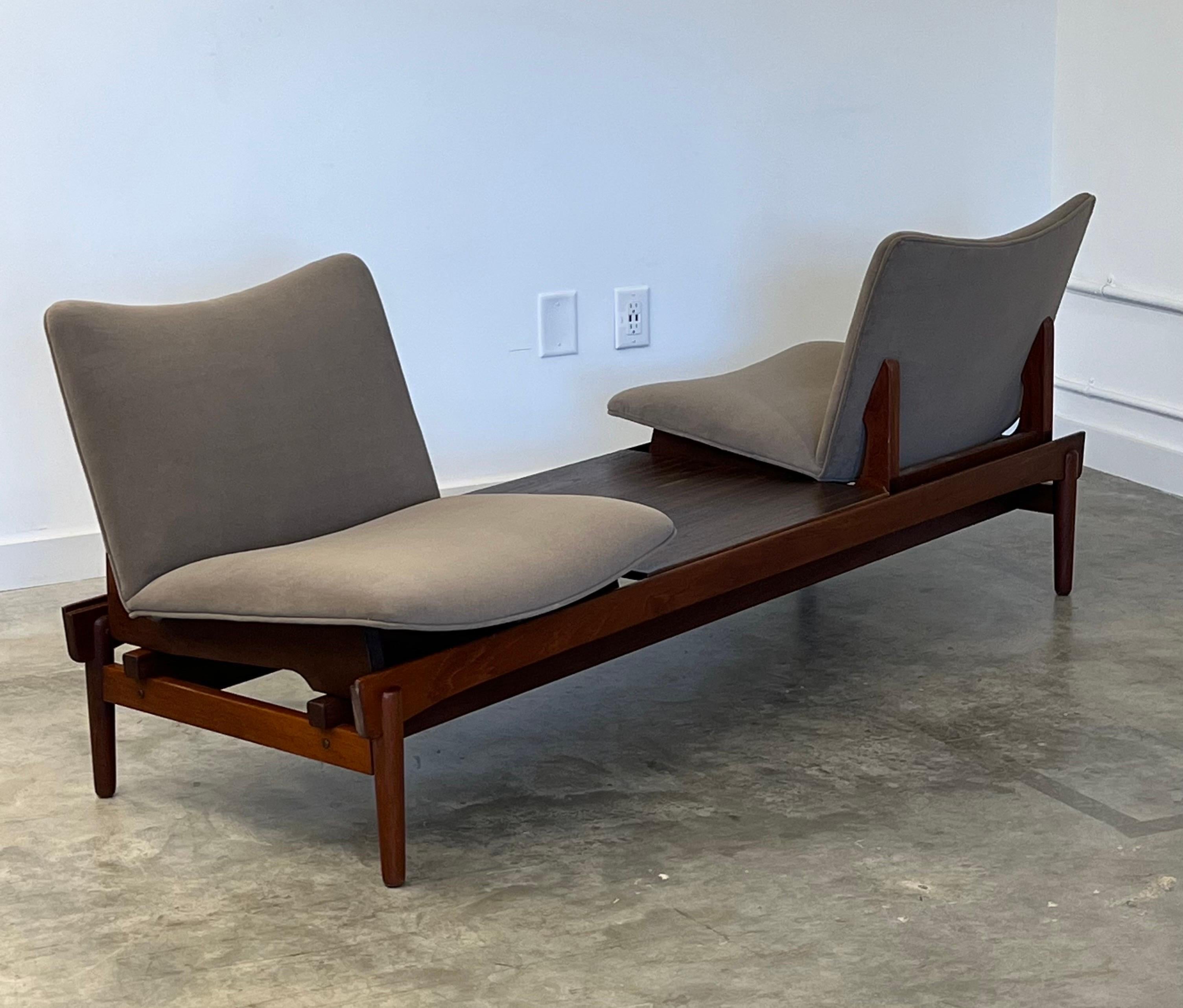 Rare sofa bench designed by Hans Olsen for Brahmin Møbler circa 1960s. Solid teak base with two seats and table insert. Modular design allows for multiple seating positions. Seats have been reupholstered in new gray suede fabric. The table insert is