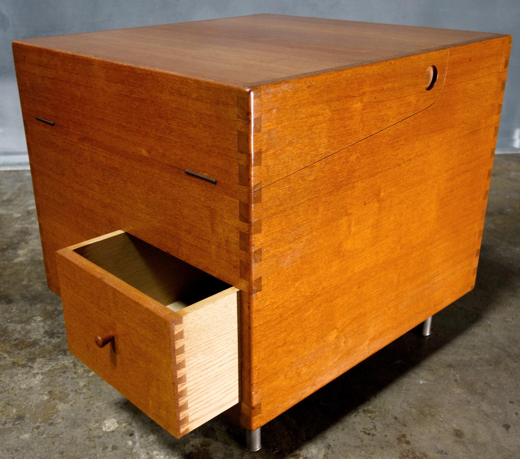 For your consideration is this rare Hans Wegner cube bar. Features one drawer and a hinged top concealing storage. Signed with branded manufacturer's mark to underside Andr Tuck design Hans Wegner made in Denmark. Denmark, circa 1960. Original and