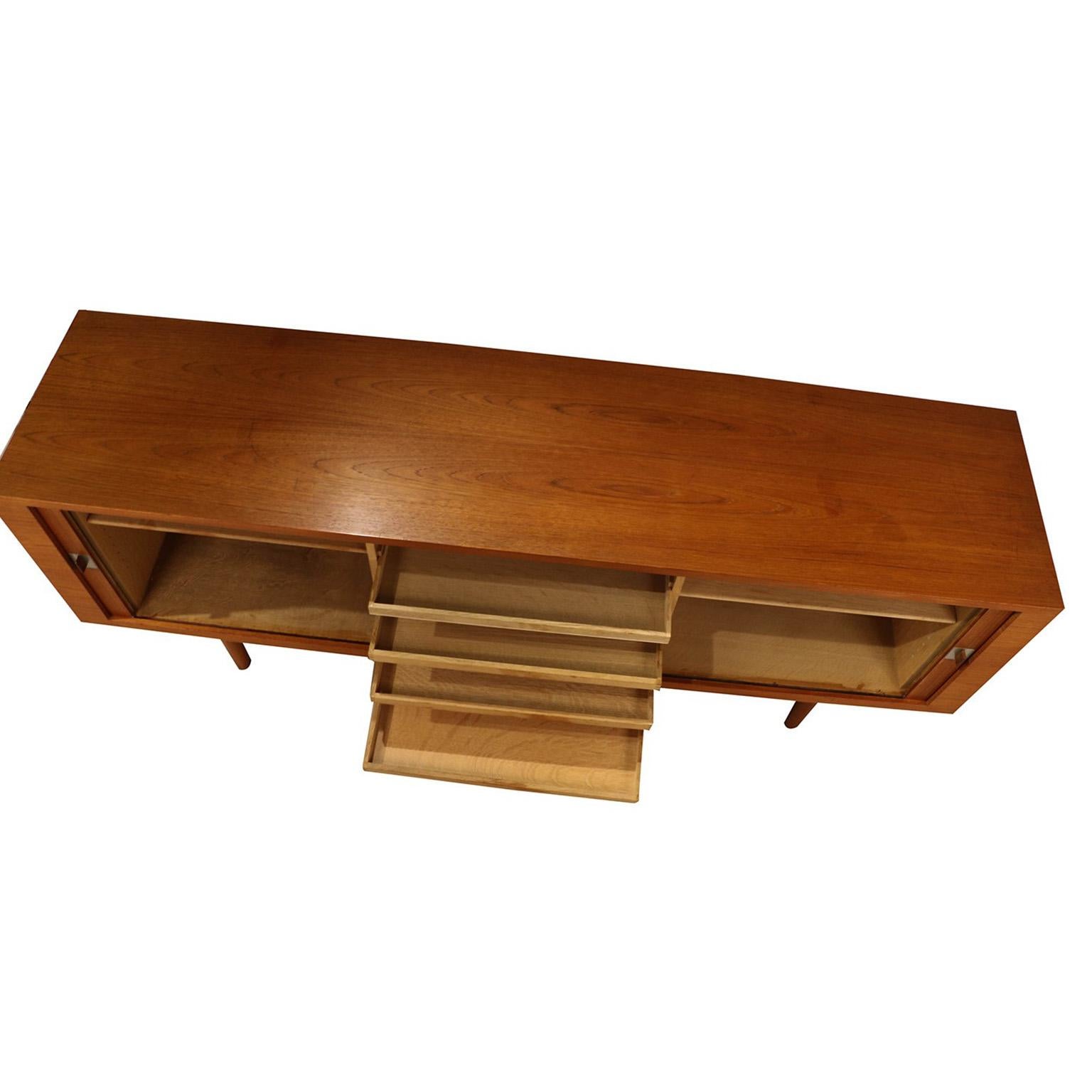 An absolutely stunning teak wood credenza model RY-25 “President” collectors credenza designed by Hans Wegner, and produced by Mobler of Denmark, circa 1965. This piece is long, low, and just stunning!!! Precisely crafted in exceptional teak grain